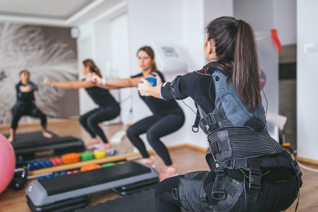 A small class trains using their full body EMS suits.