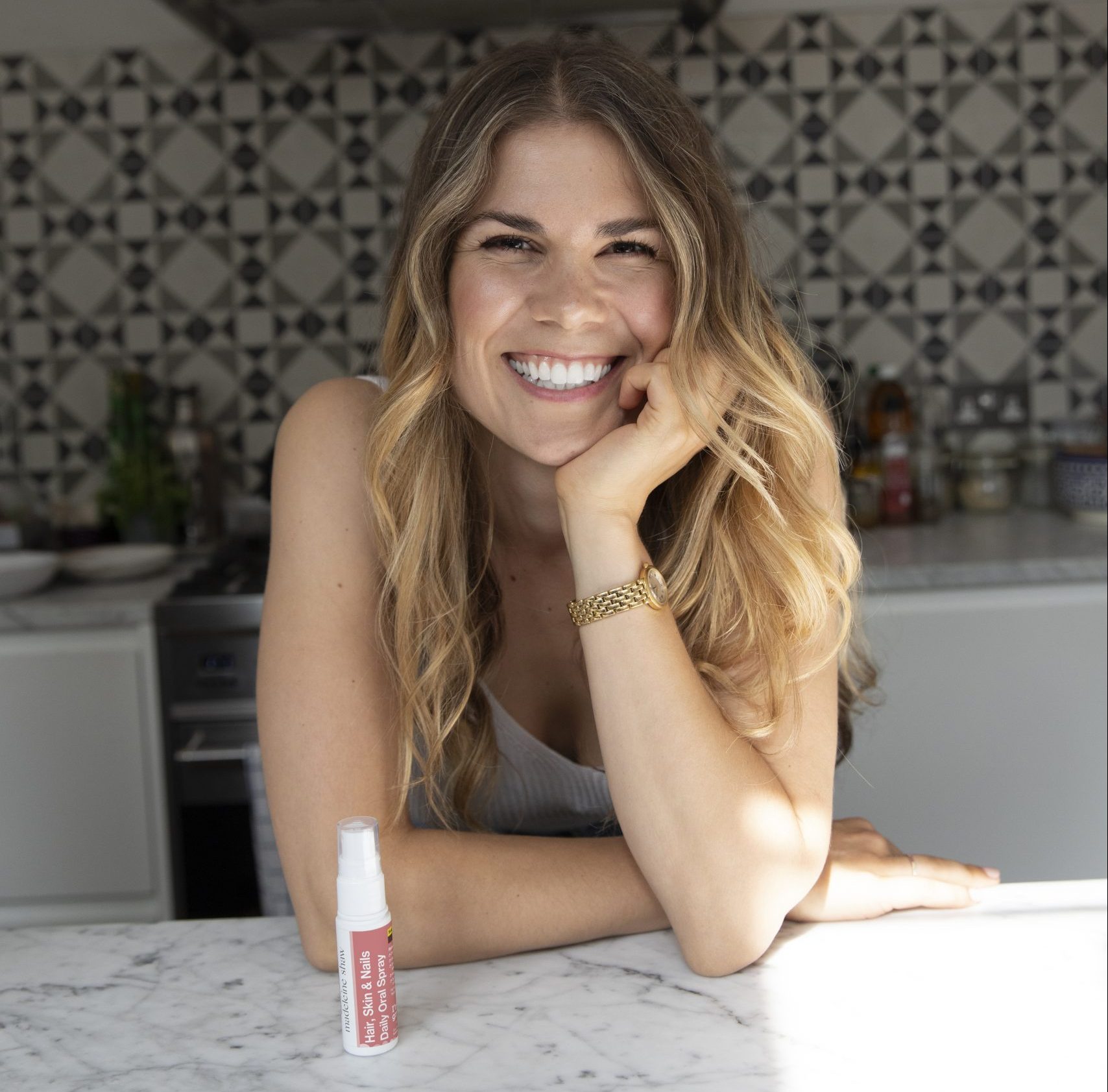 Madeleine Shaw smiling in her kitchen.