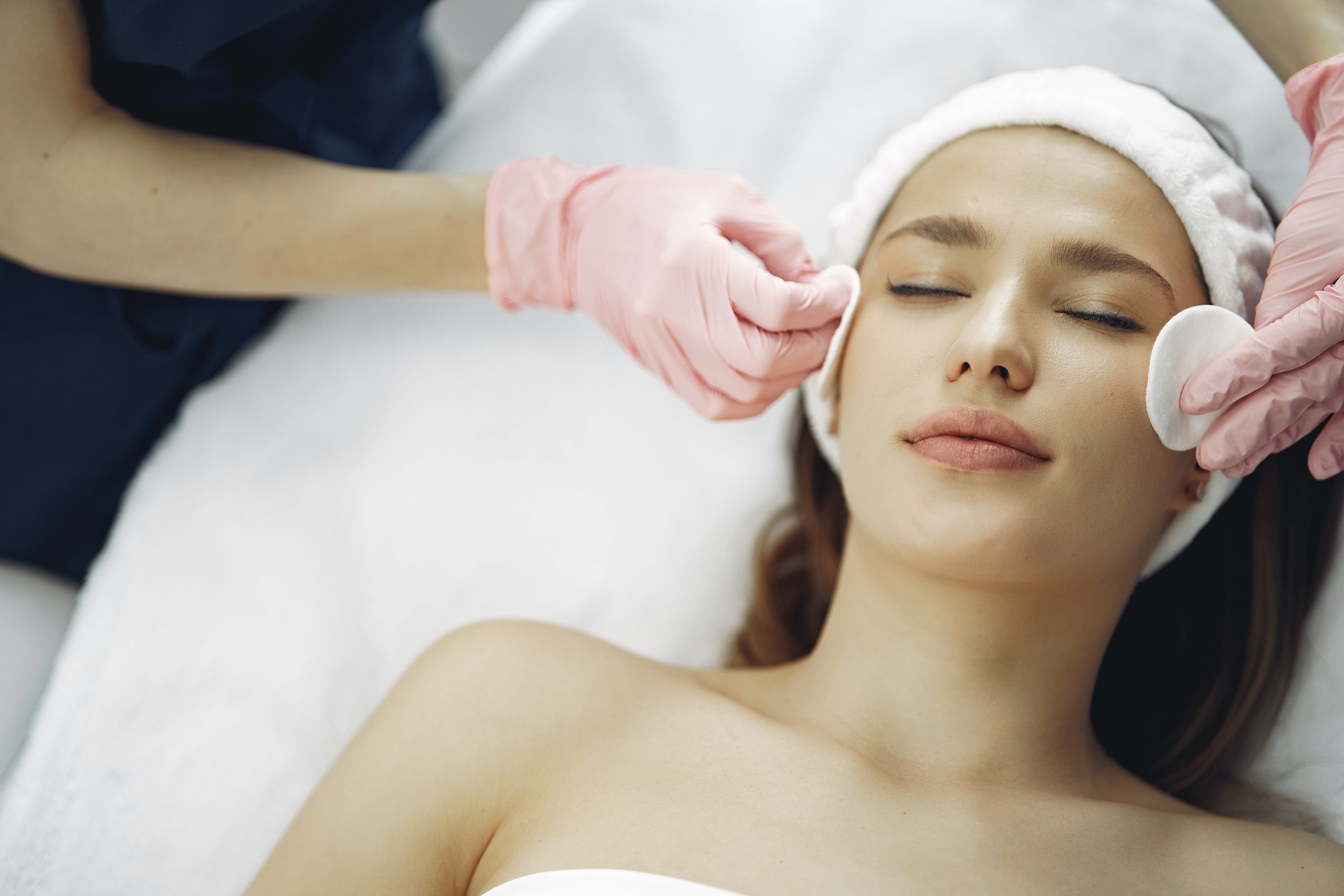 A woman undergoing a skin care treatment on her face.