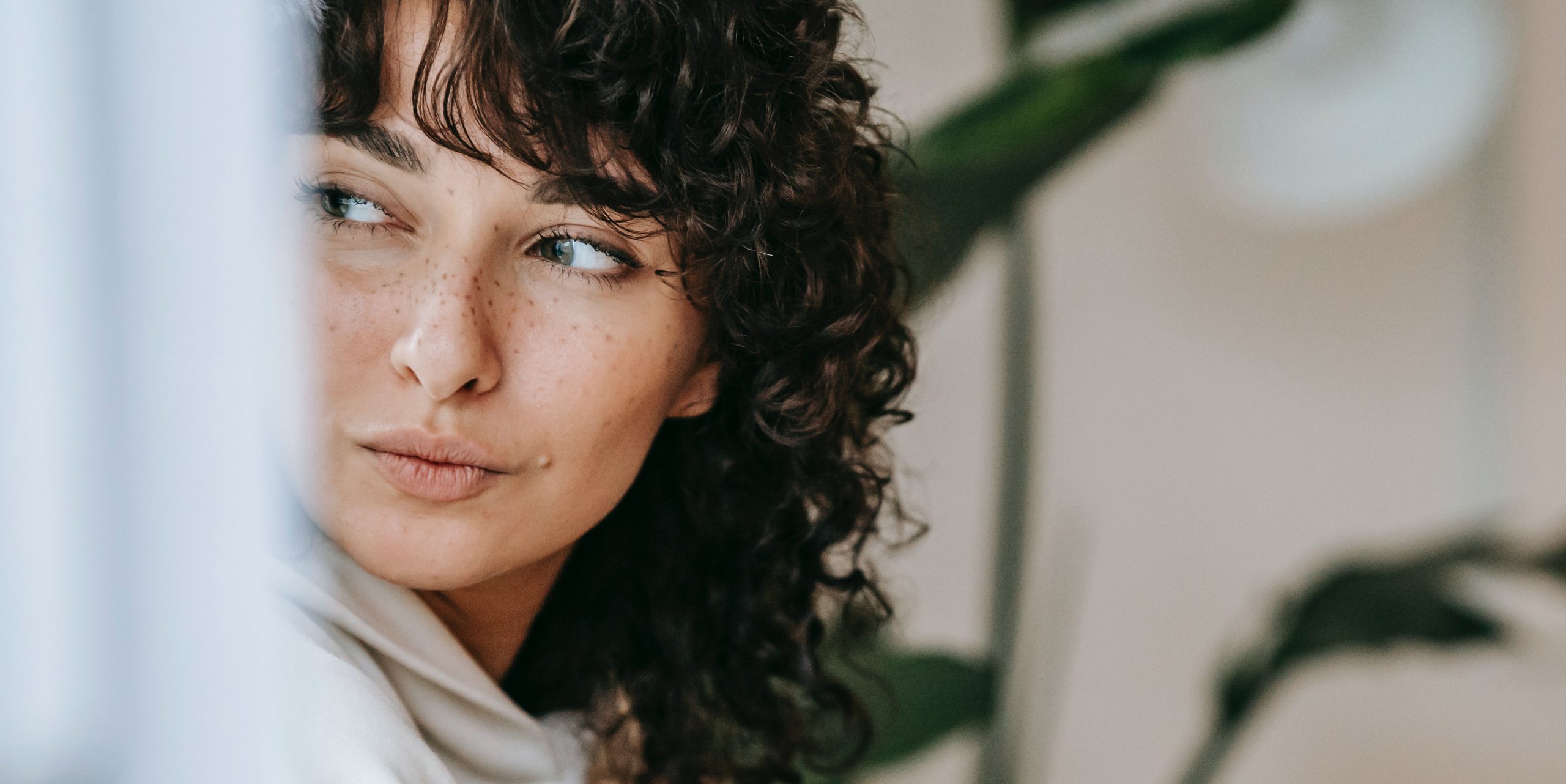 The face of a woman with freckles - the most common type of hyperpigmentation.