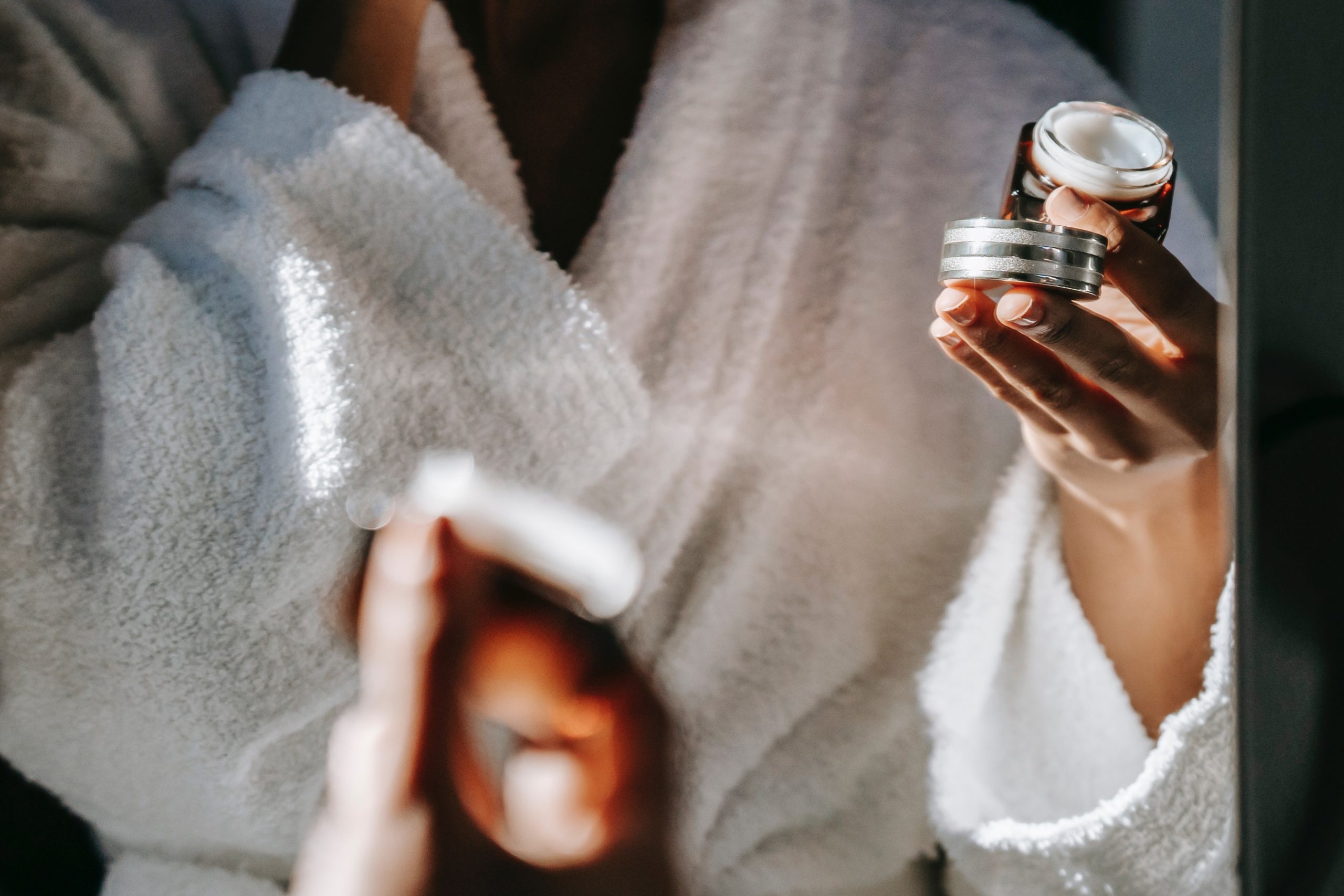 A woman moisturises her skin.