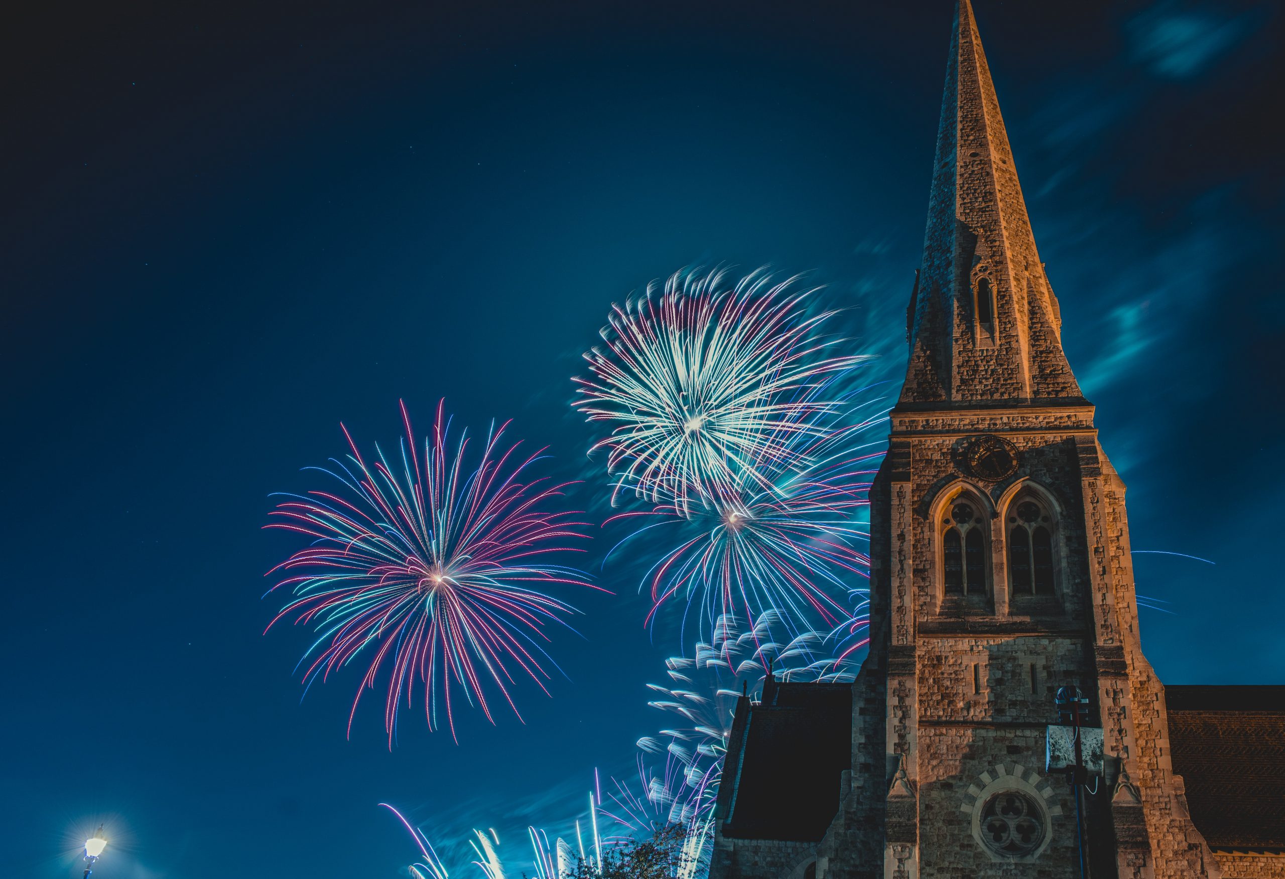 Red and blue fireworks lighting up the night sky of London