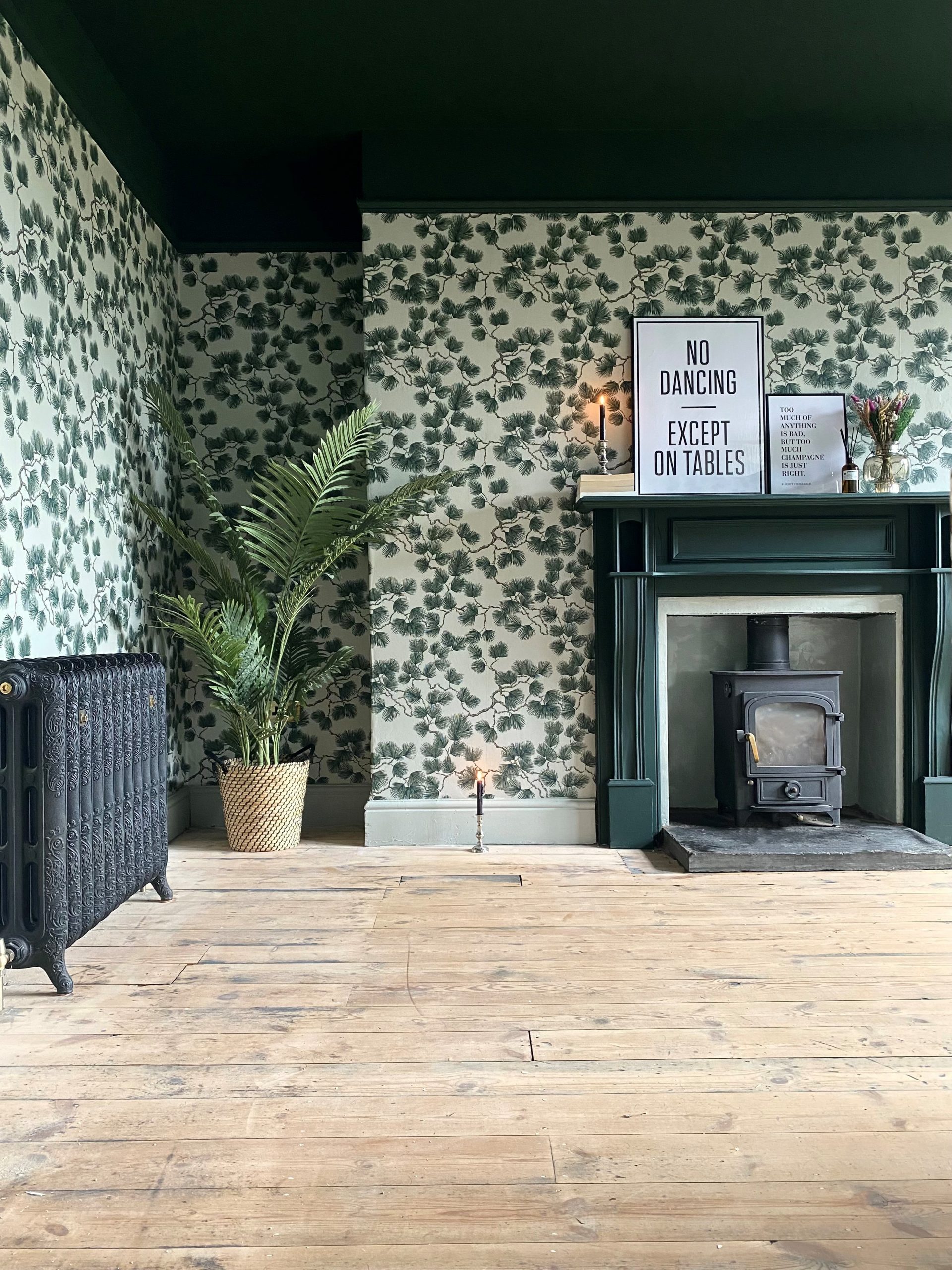 A modern living room renovation with dark ceiling and wooden floor by interior designers Making Walford Magical