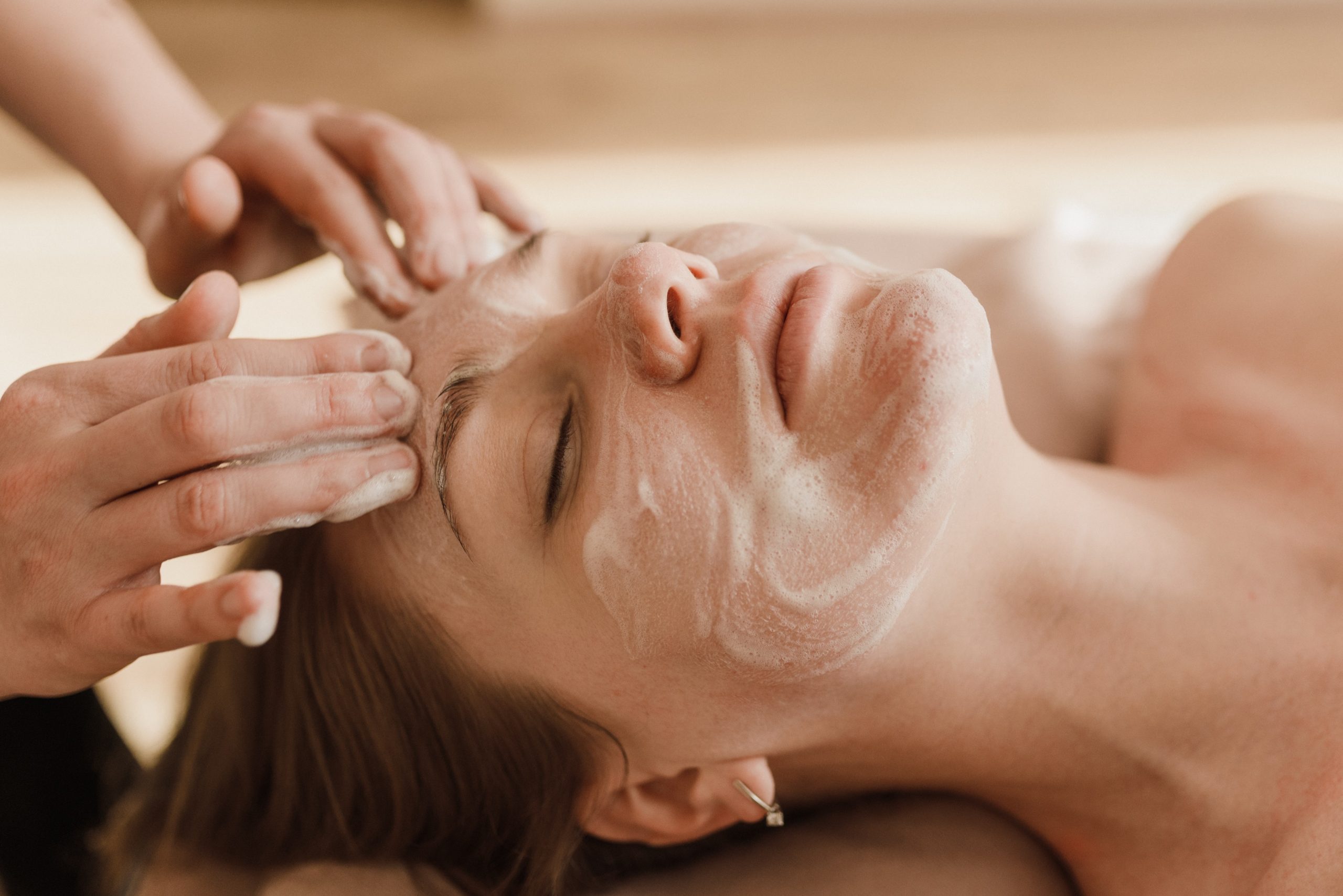 A woman receives a beauty treatment on her face