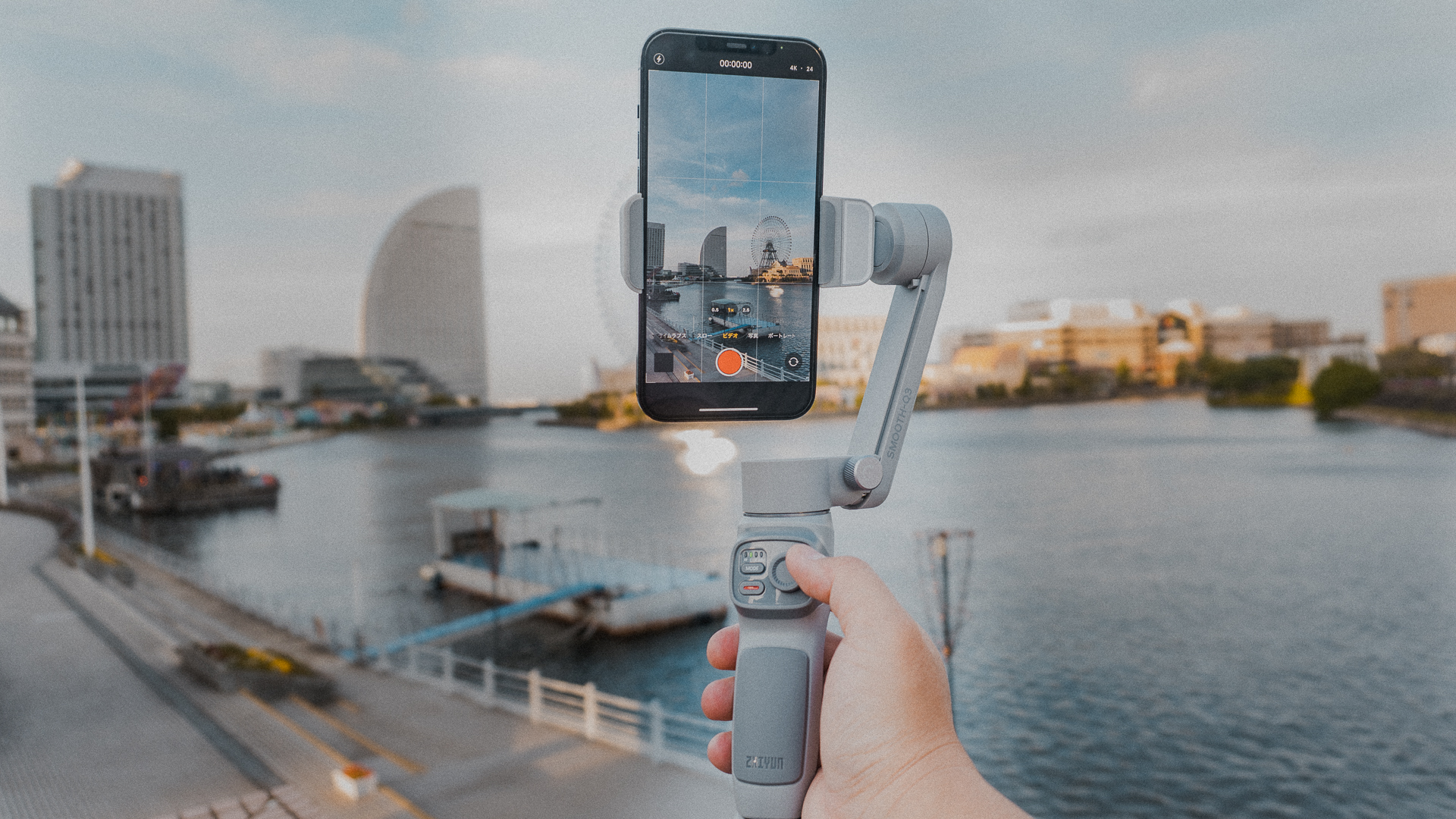 A man records his holiday using a smartphone on a Zhiyun Smooth Q3 gimbal to capture steady images