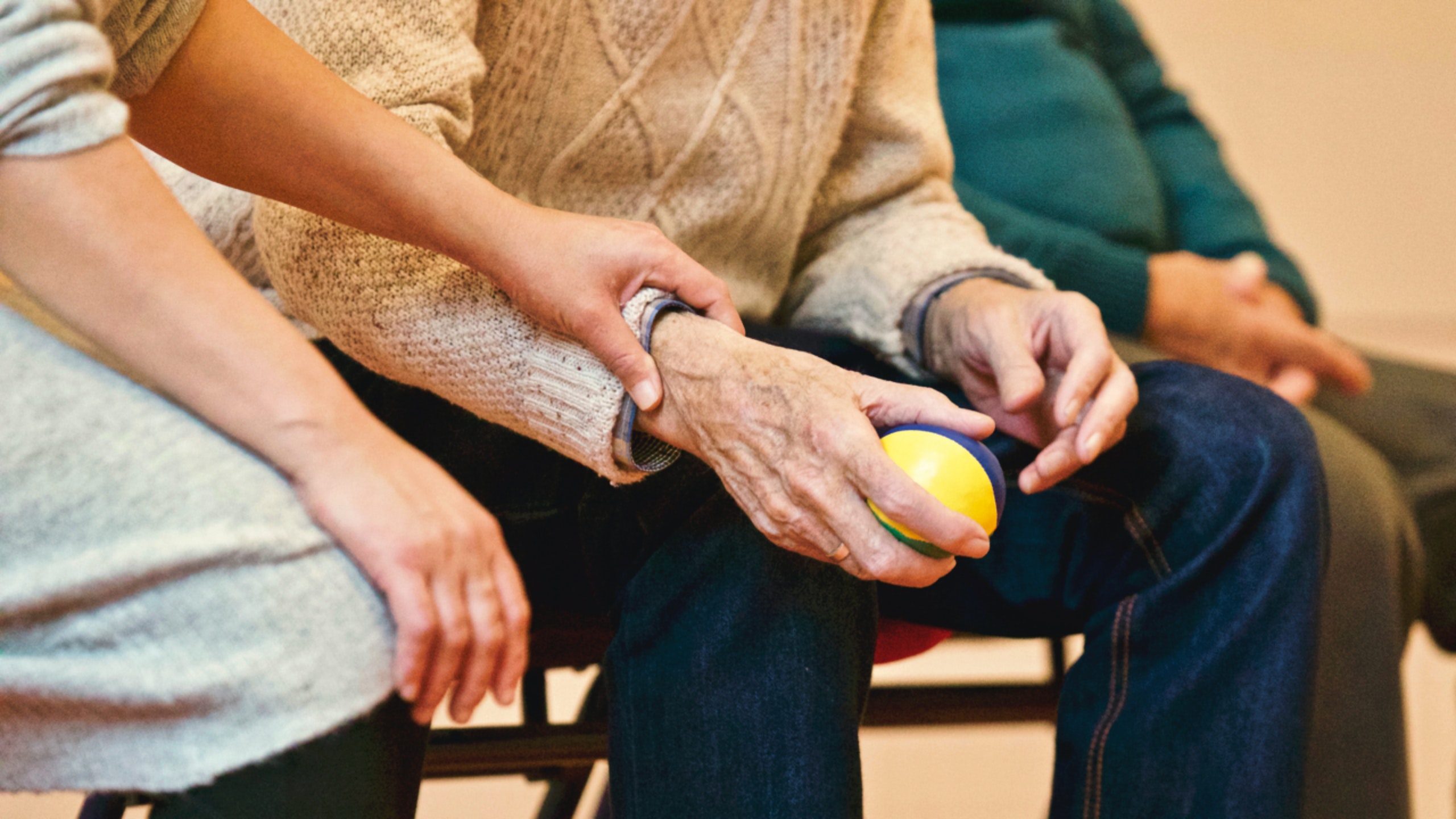 A woman comforts an elderly neighbour by being there for him.