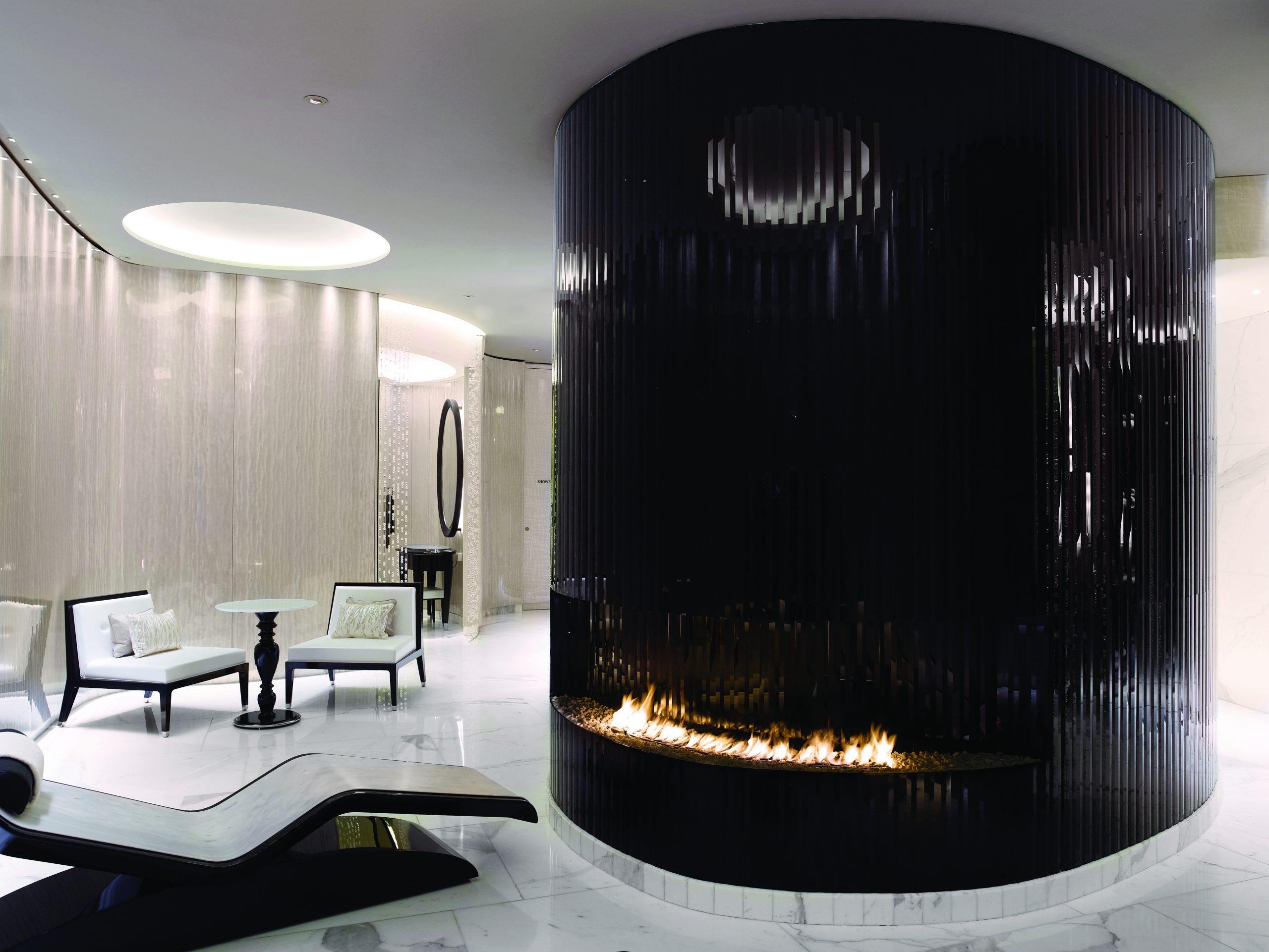 A luxury Corinthia Hotel in London showcasing a spa with a fireplace.