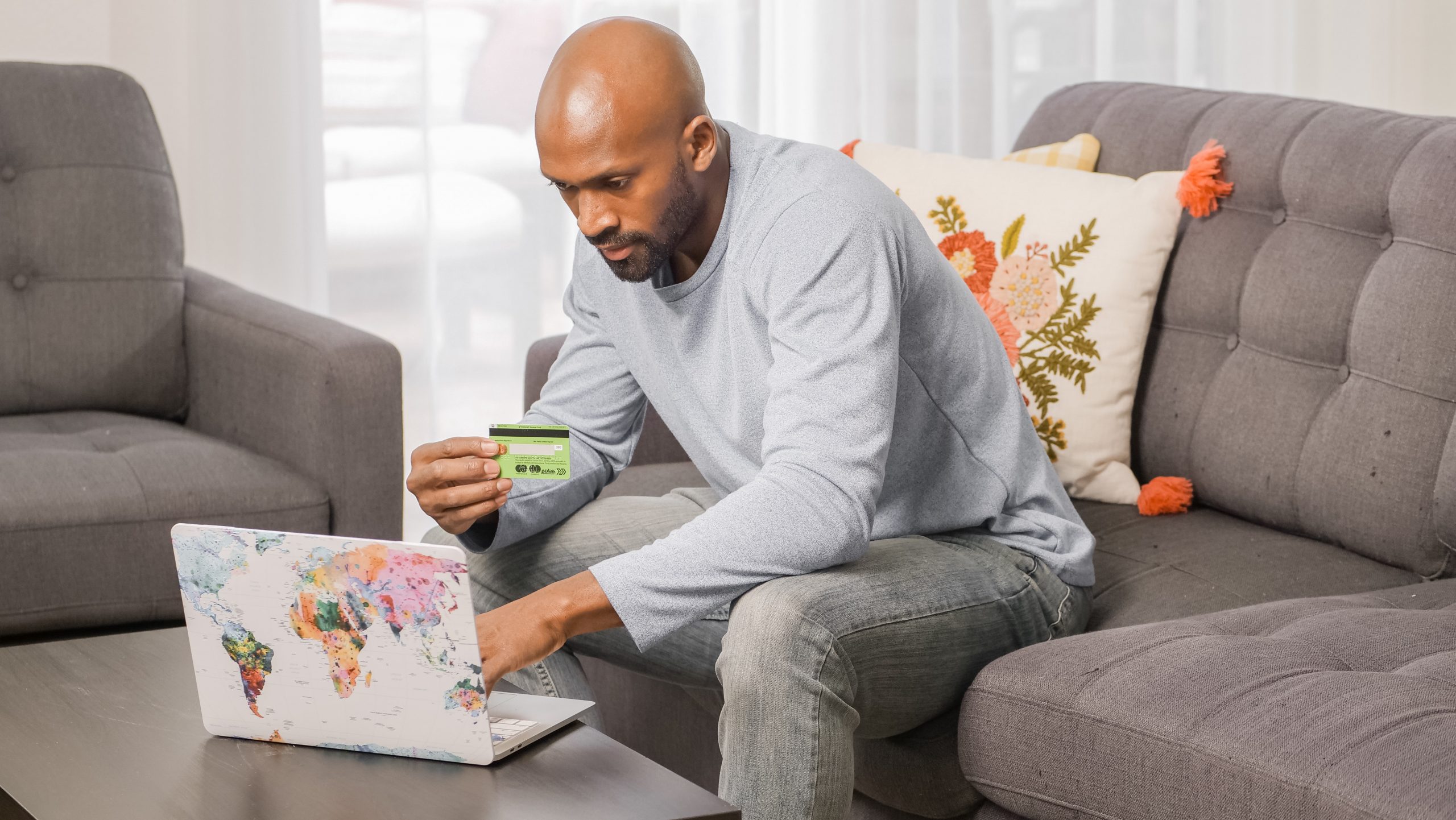 A black man invests in a savings accounts using his laptop.