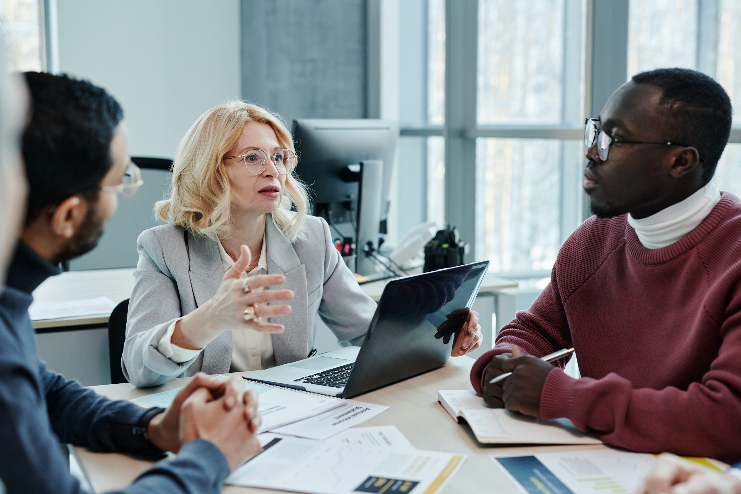 A businesswoman in a meeting enjoys the benefits of job sharing.