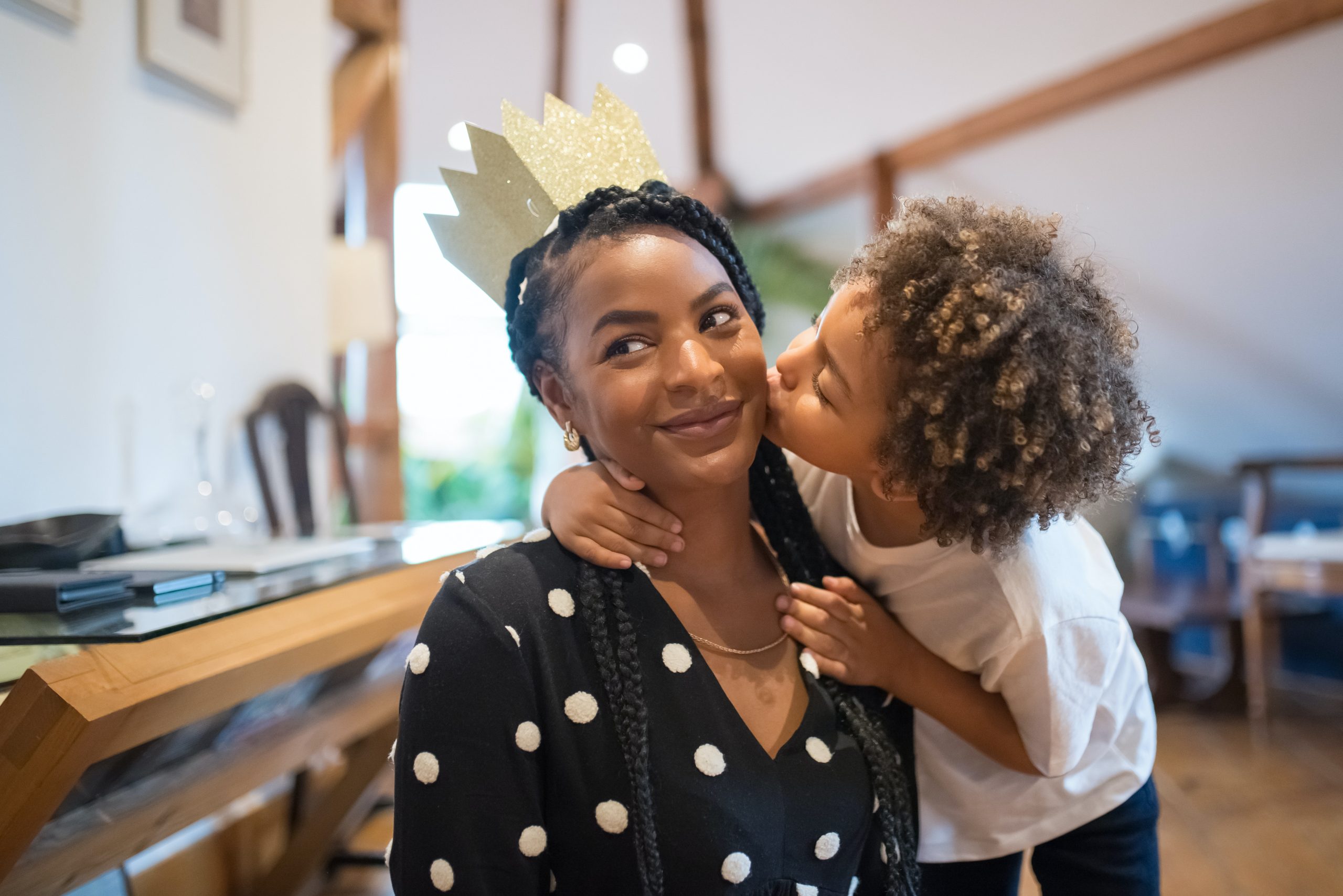 A young mother being kissed by her young son.