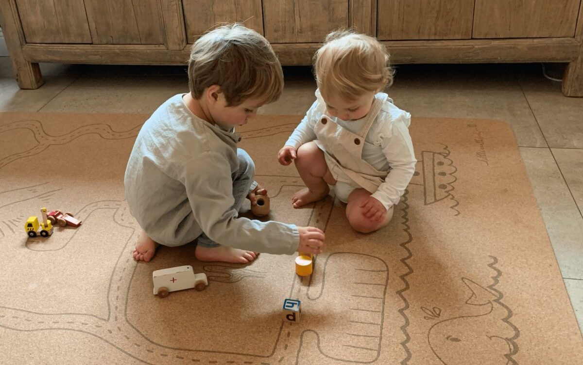 Two young children play on a Pure Earth Collection's non-toxic play mat