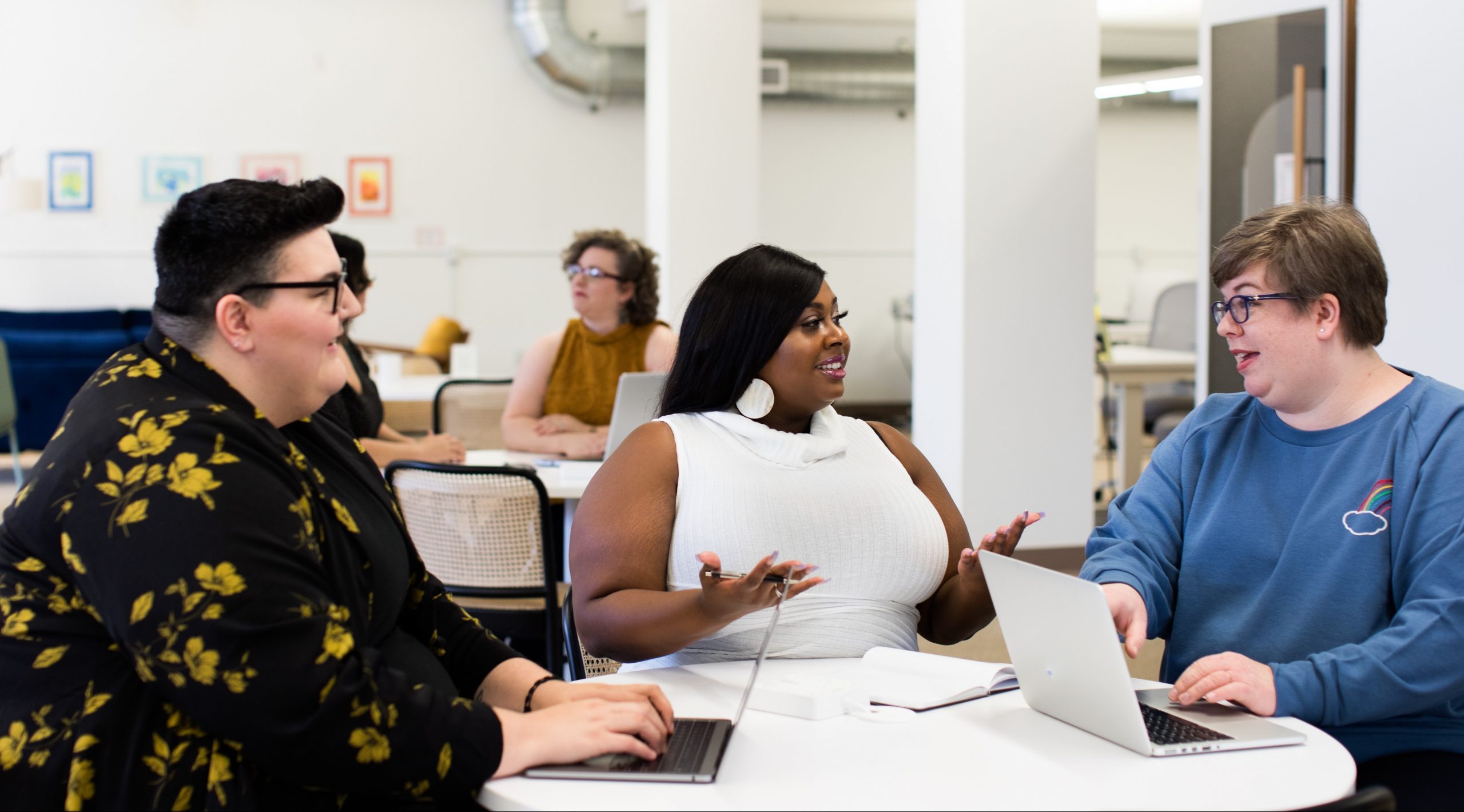 Three overweight women of different backgrounds and ages have a business meeting. 