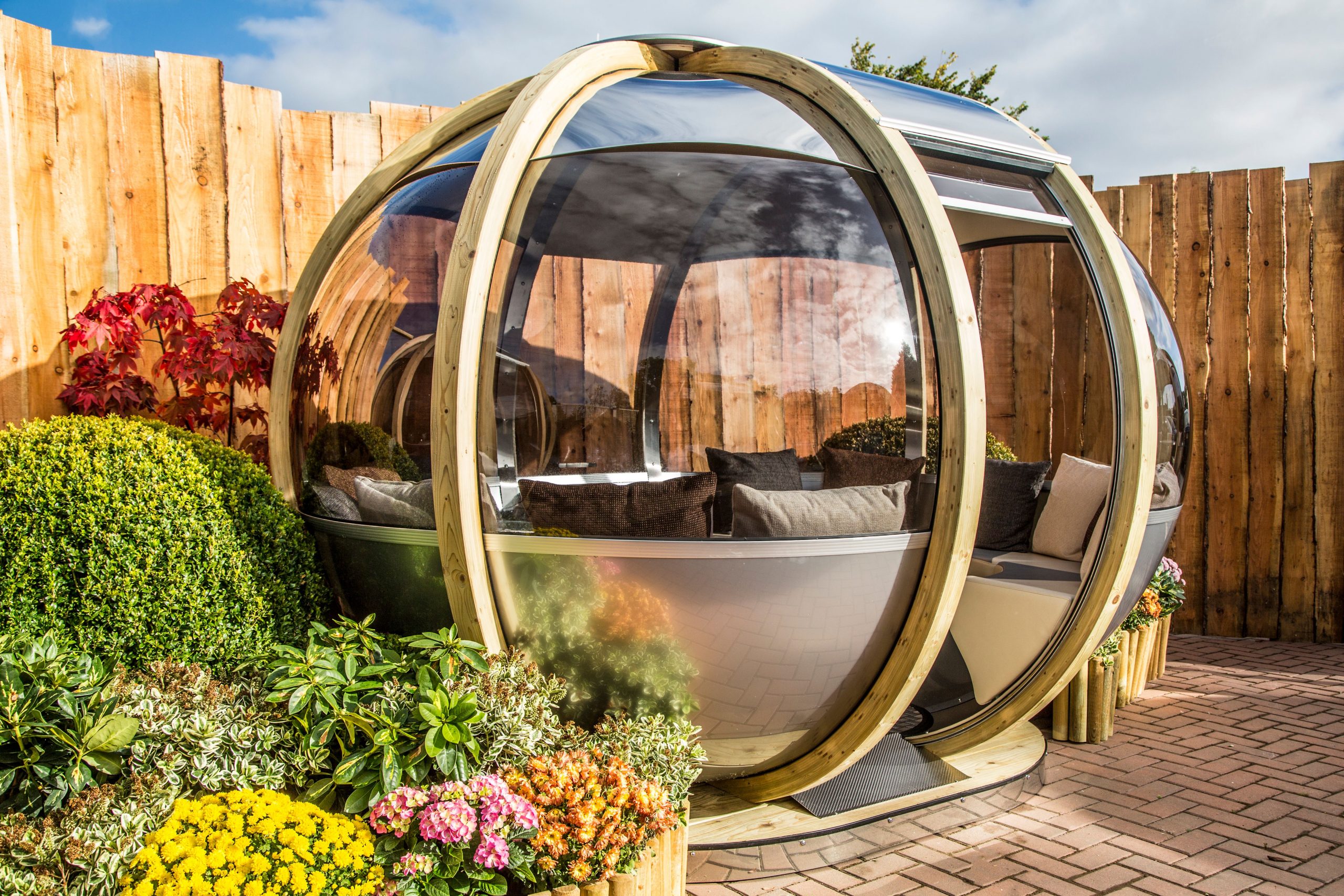 A Summerhouse Garden Pod from limlace.co.uk at the bottom of a garden.