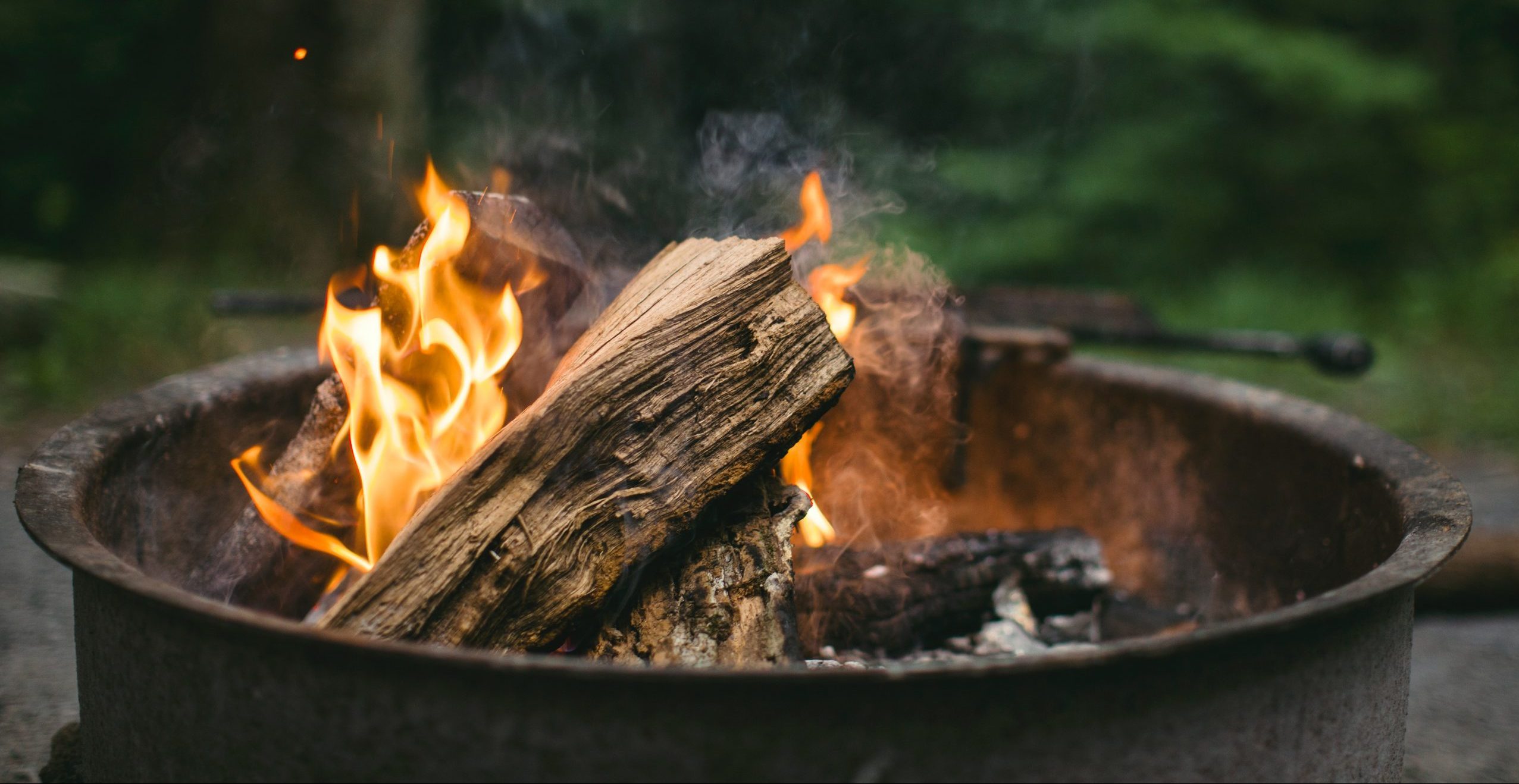 Logs burning in a firepit.