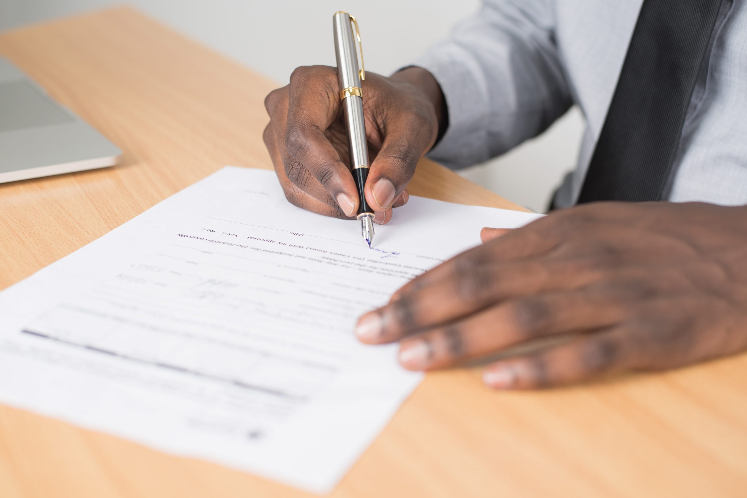 A man signing the deeds of his legacy gift.