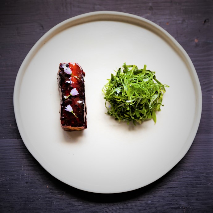 A slice of pork served with salad at restaurant Rastella, Merchants Manor
