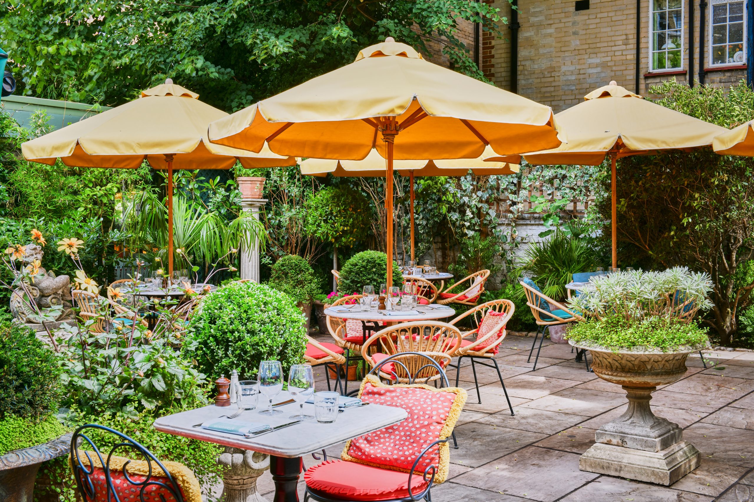 The English-style garden dining area of The Ivy Chelsea Garden, London.