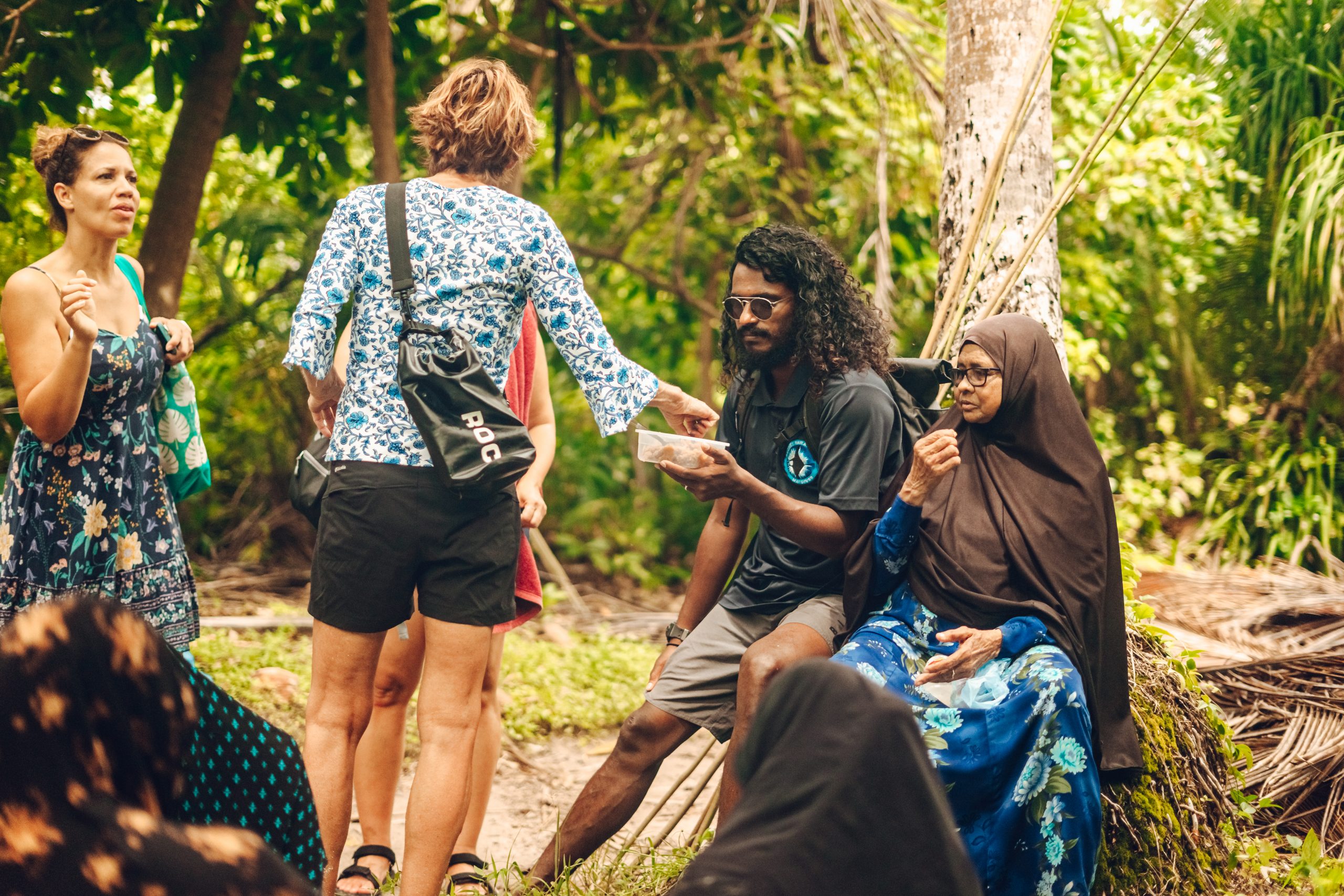 A group of tourists enjoying a snack during a break from island-hopping.