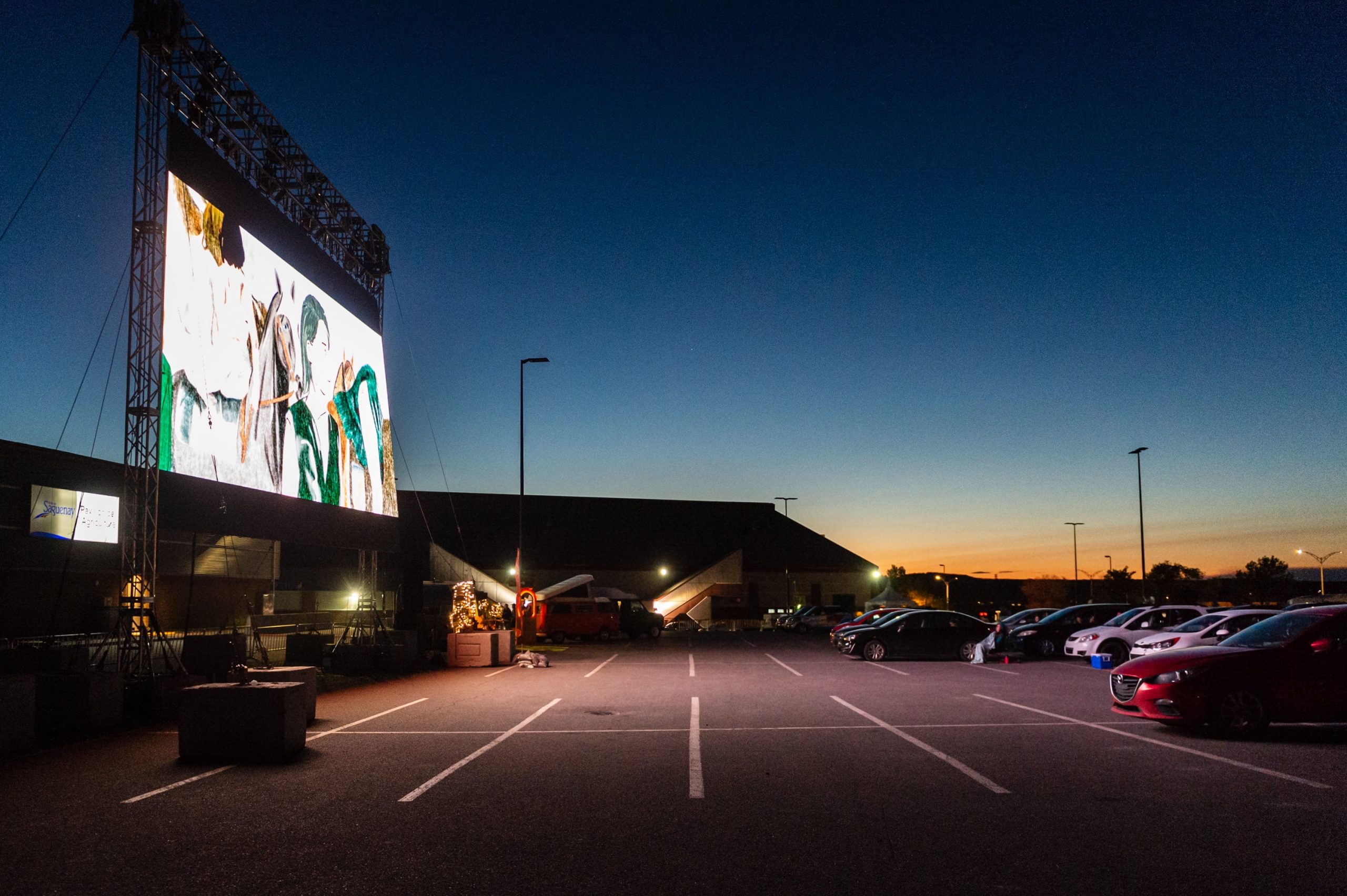 Cars parked at a drive-in cinema