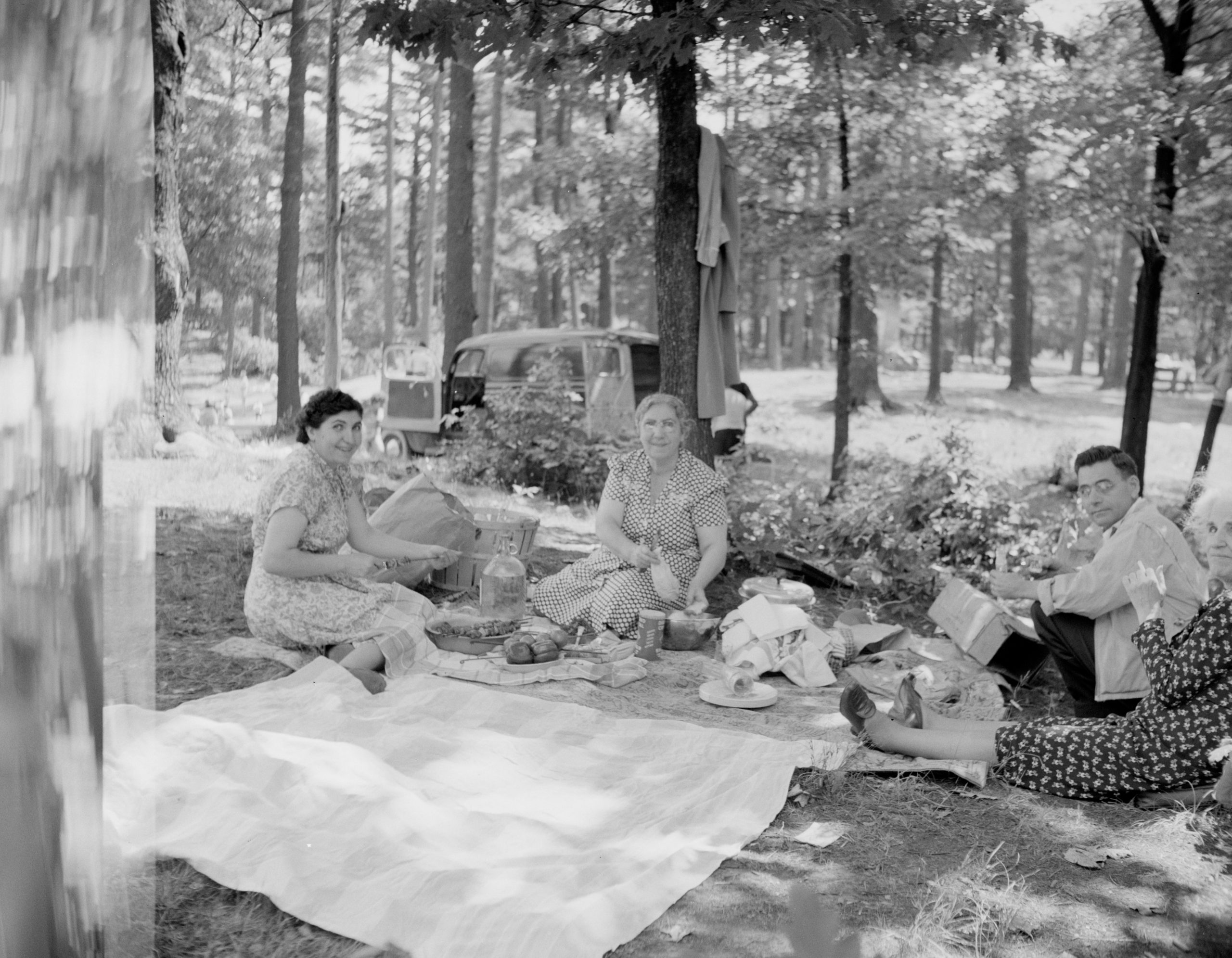 A black and white photo of a family picnic at Houghton's Pond, Milton, Massachusetts from the 1950s.