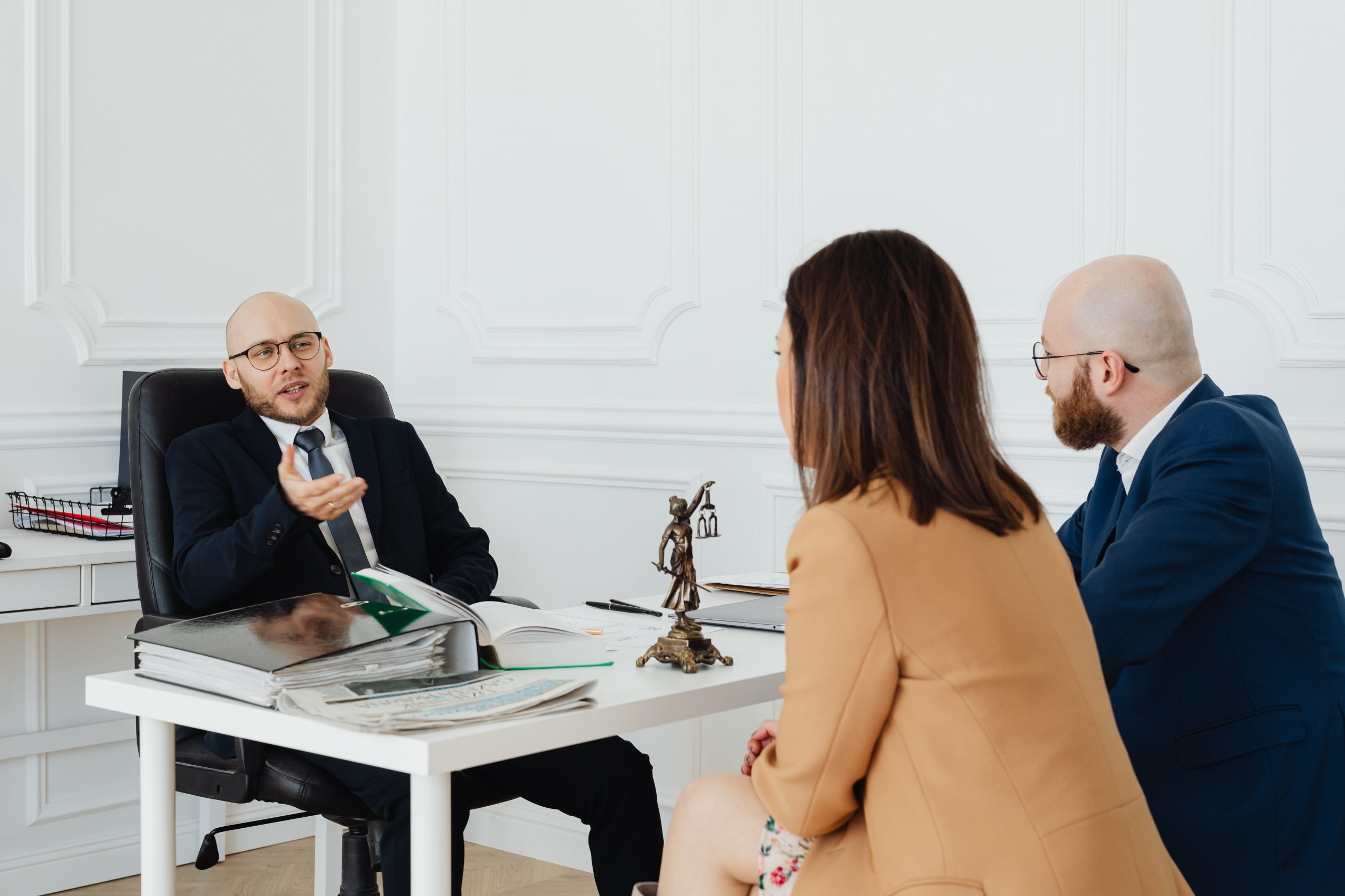 A couple listening to a lawyer's professional advice.