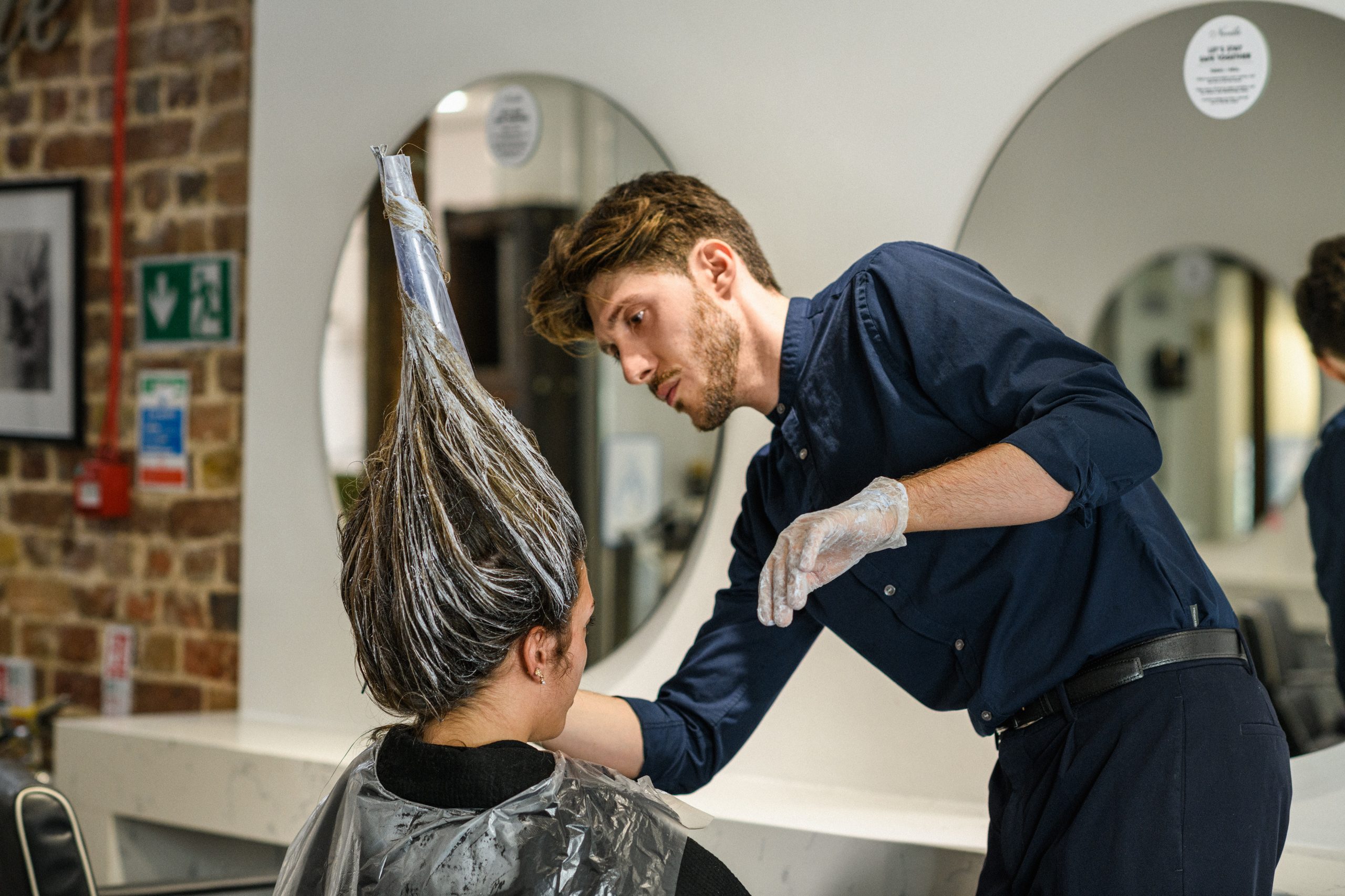 Hair expert Domenico Casella dyeing a client's hair.