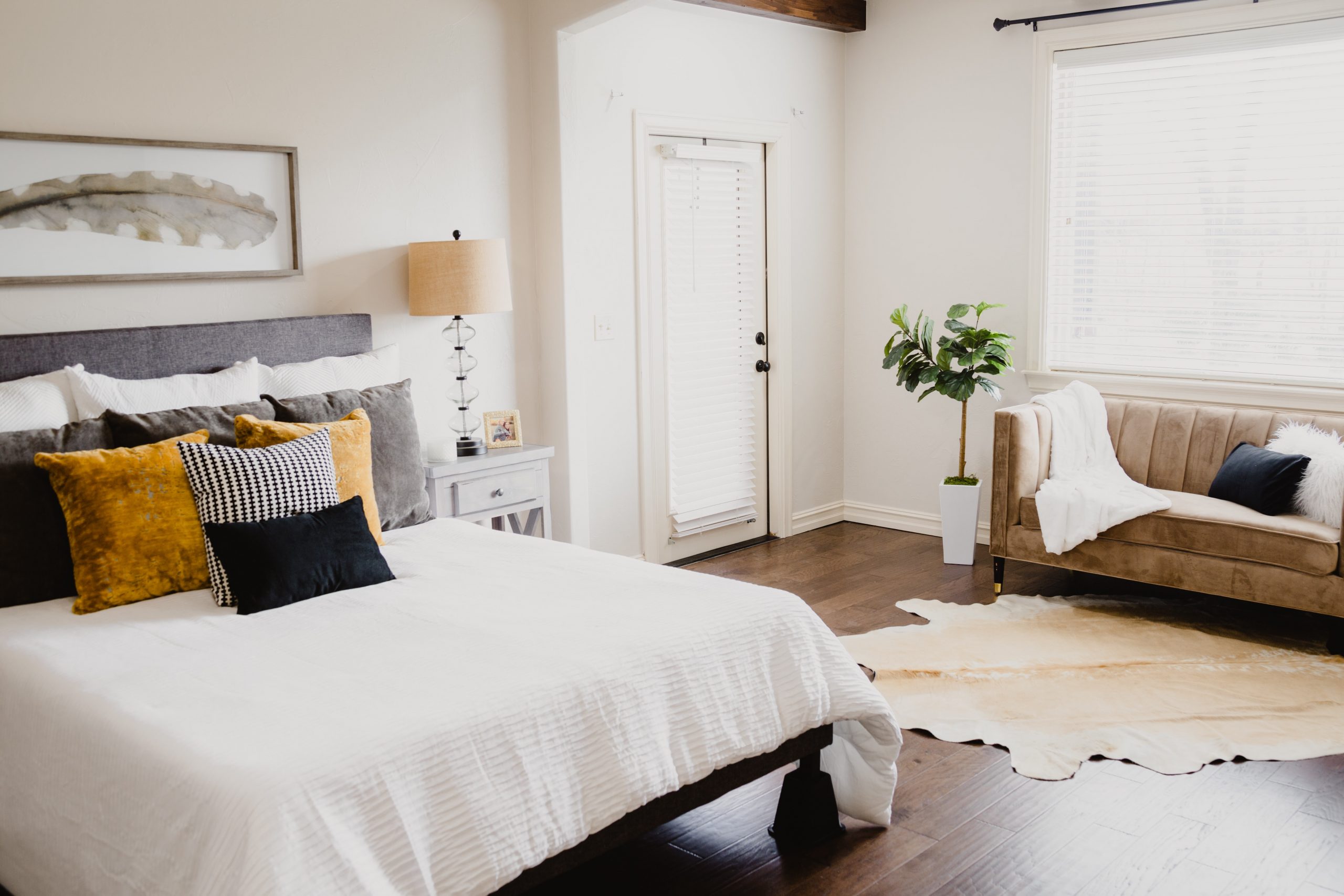 A calm, relaxing bedroom decorated in shades of white, grey and brown.