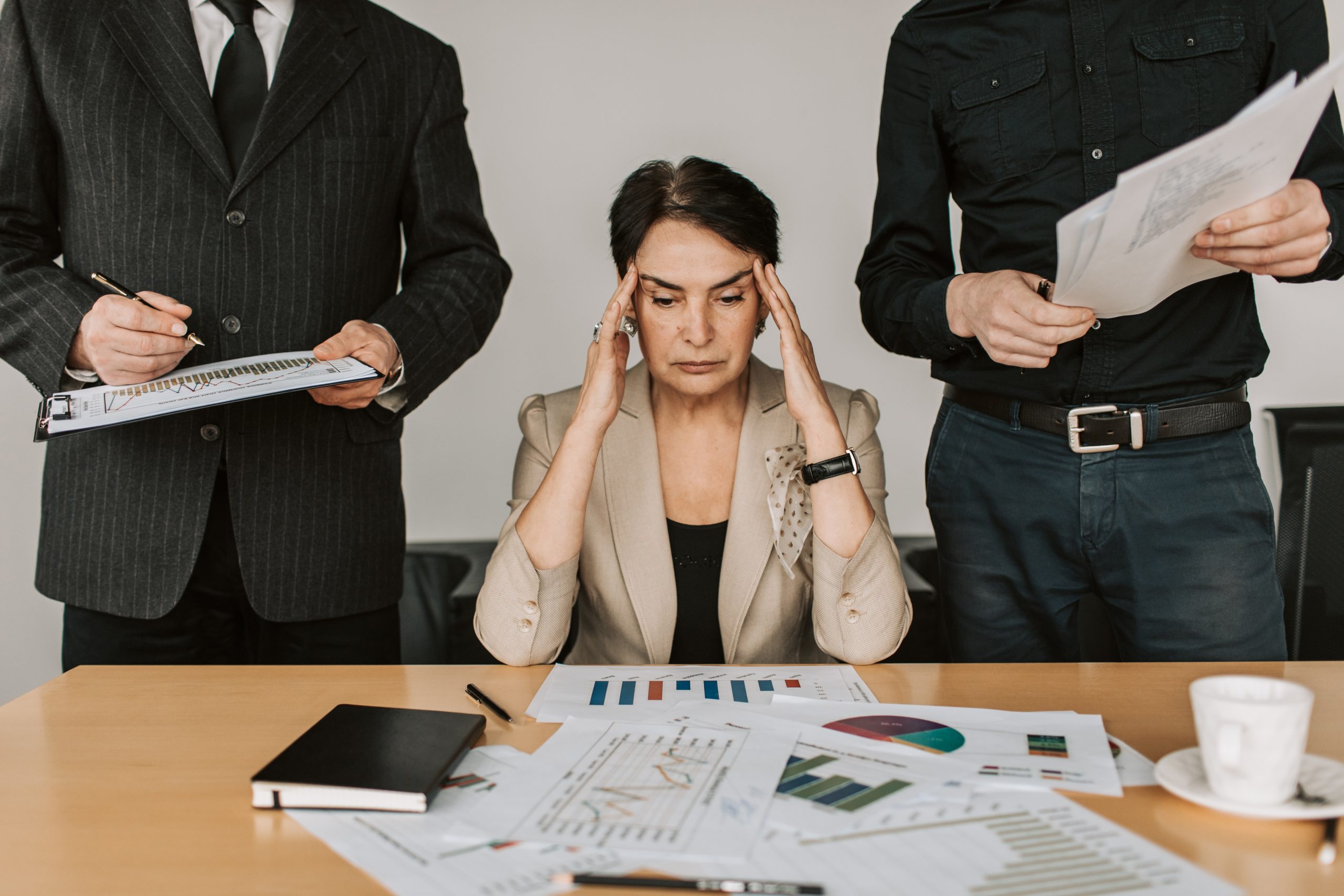 A senior businesswoman snowed under with work.