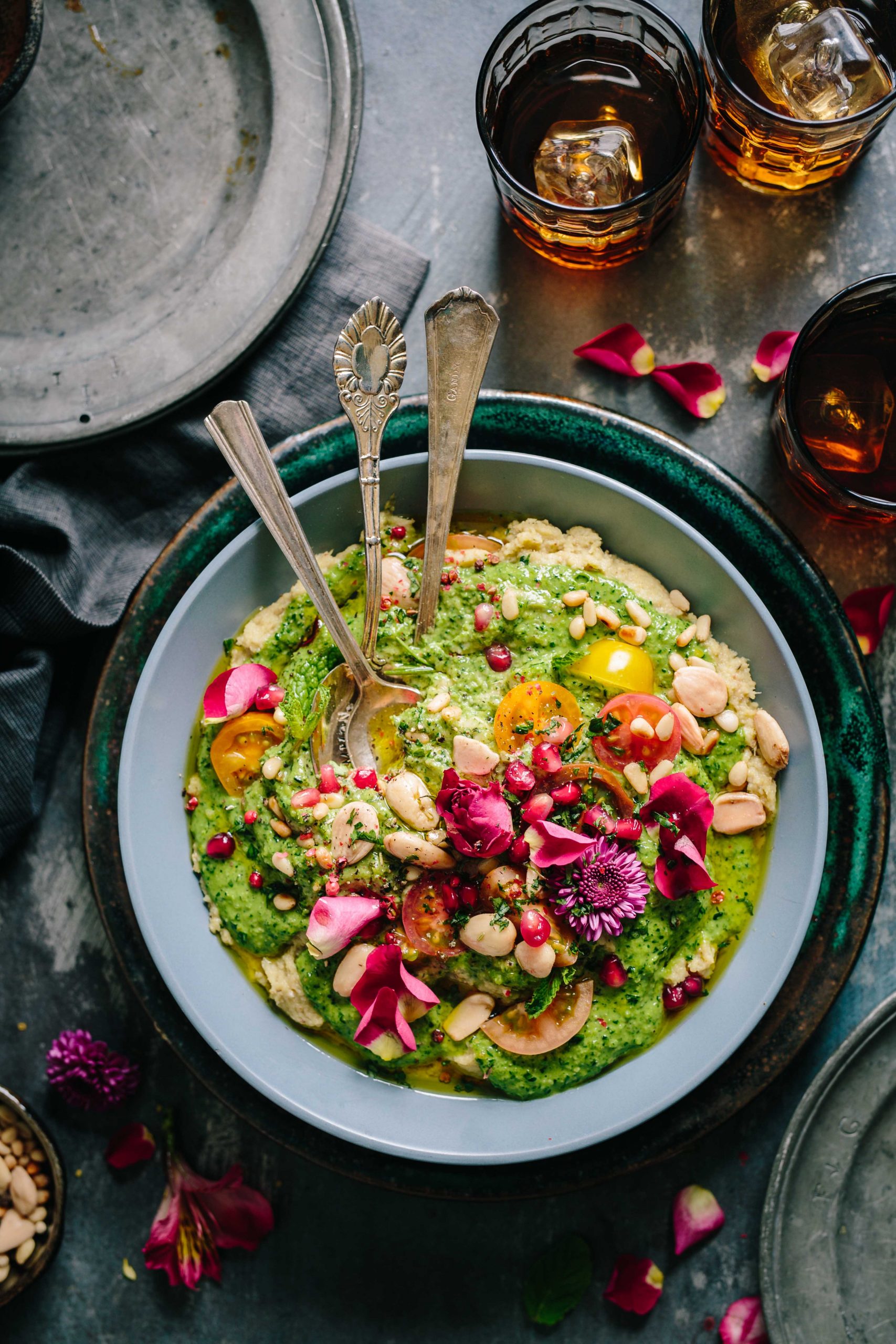 Broccoli and butterbean dip, served with almonds, pomegranate seeds and flower petals.