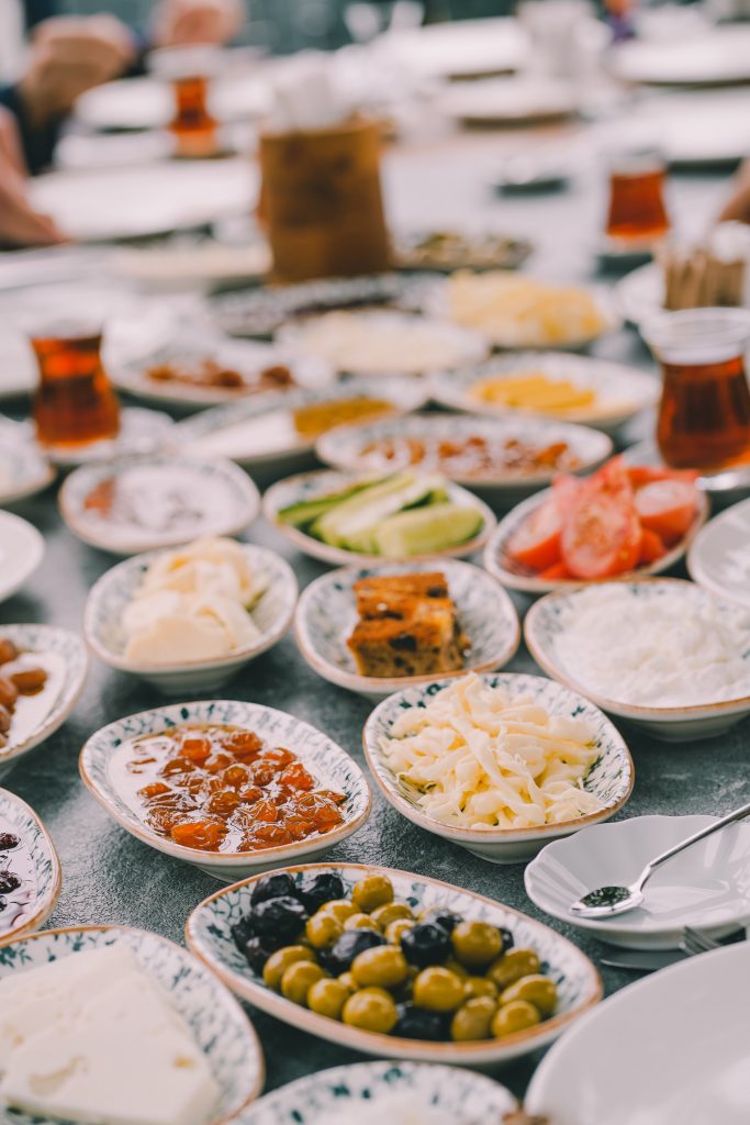 A traditional Turkish breakfast; plates of olives, vegetables, cured meats, cheeses, dips and sauces.