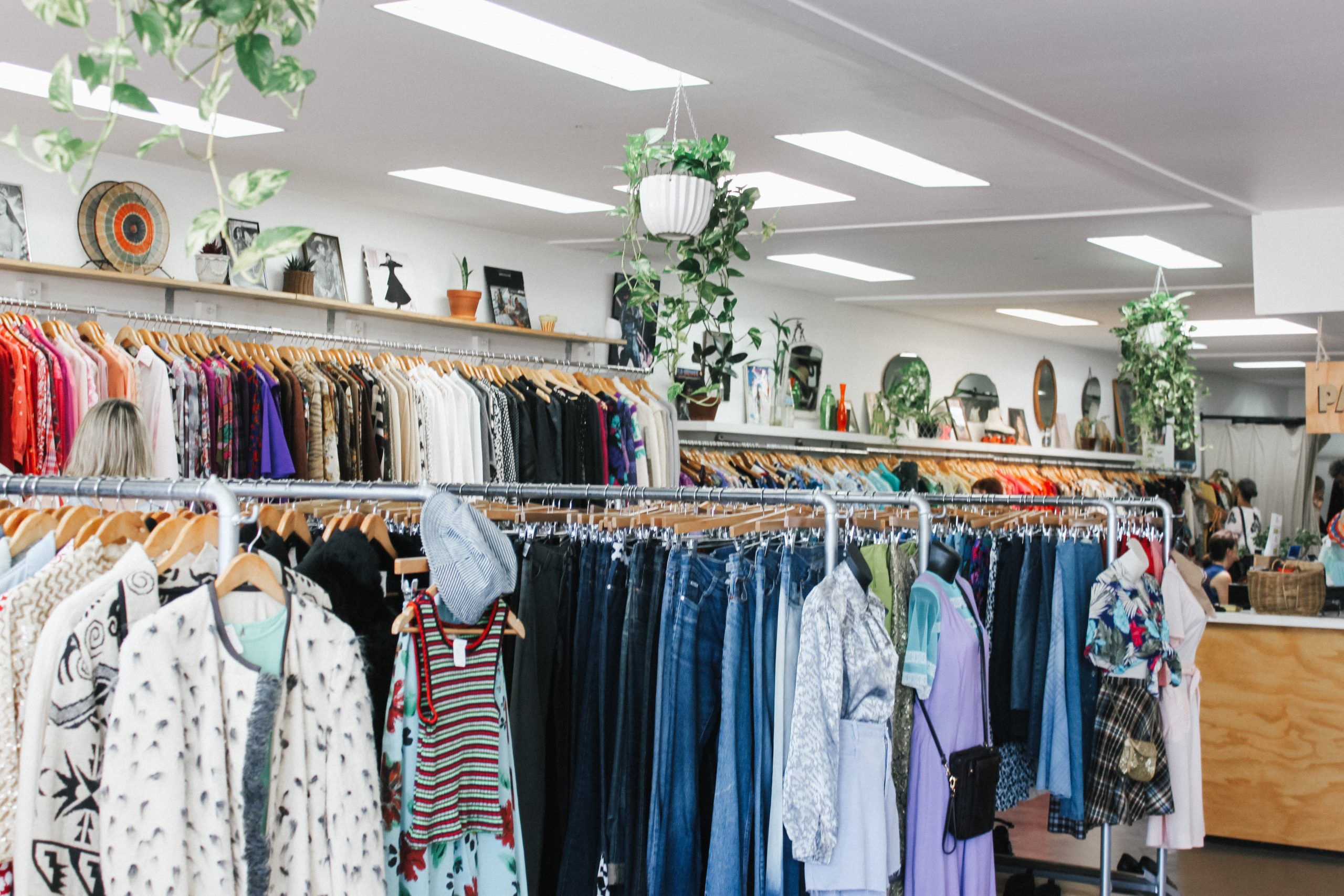 A charity shop full of clothes for sale.