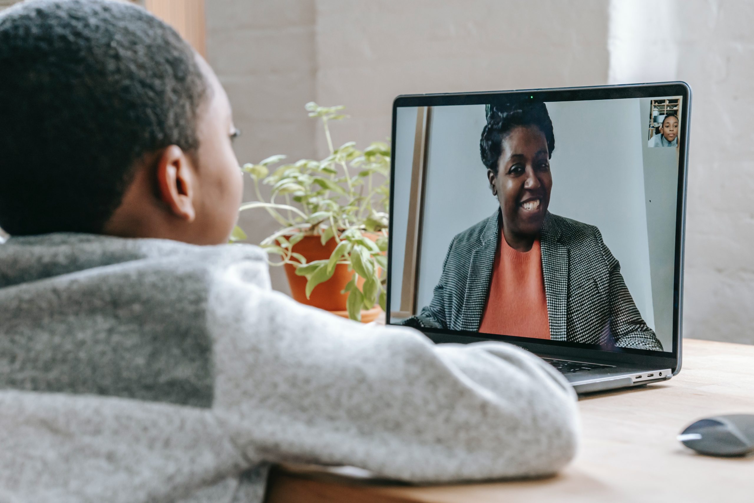 A young black child suffering from long covid attends an online class.