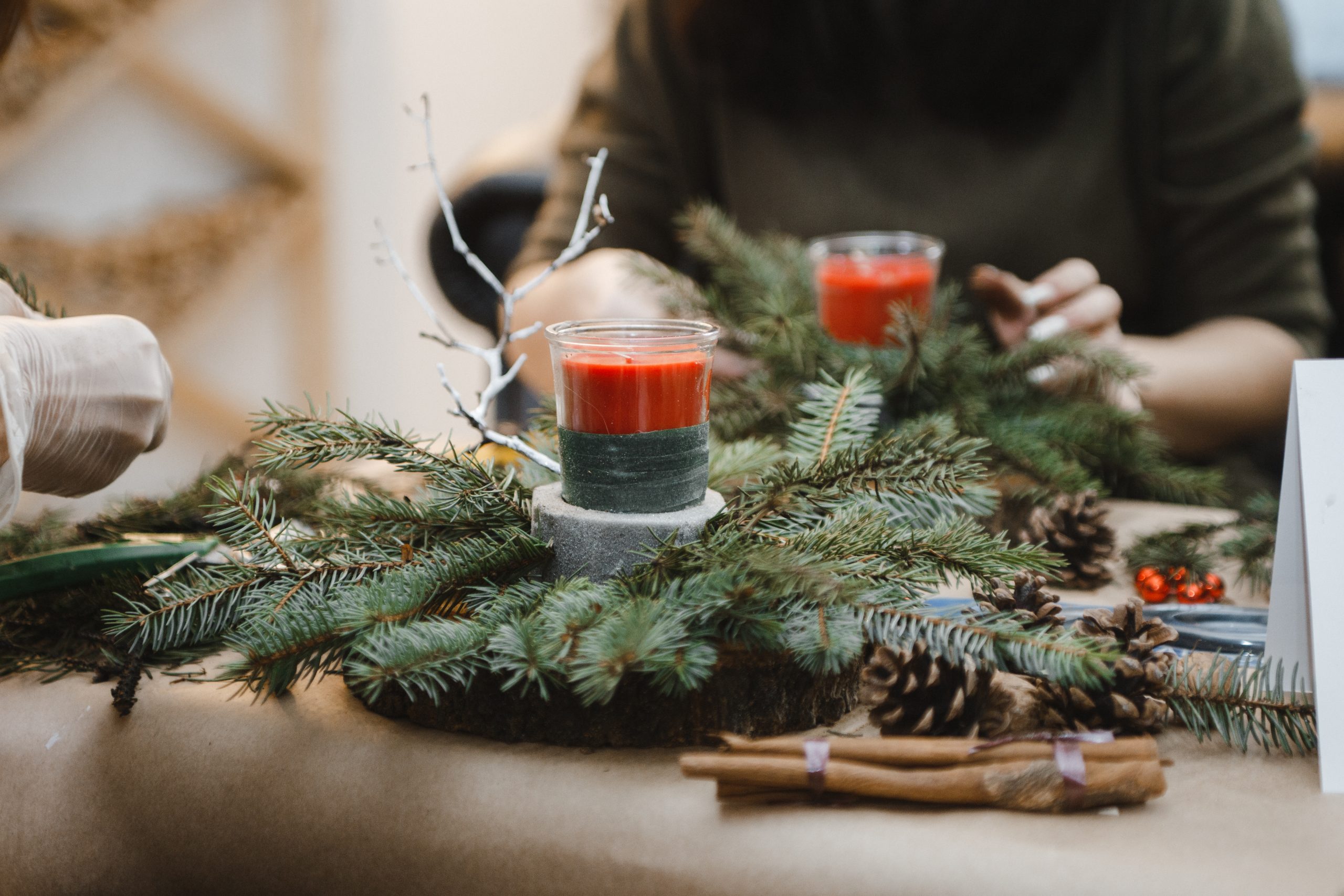 Home-made Christmas candle holders decorated with pine branches.