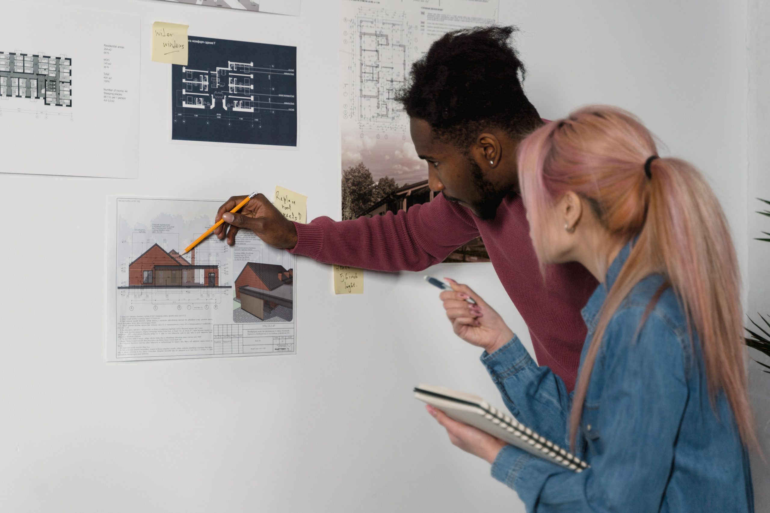 Man and woman working on a plan at the office.