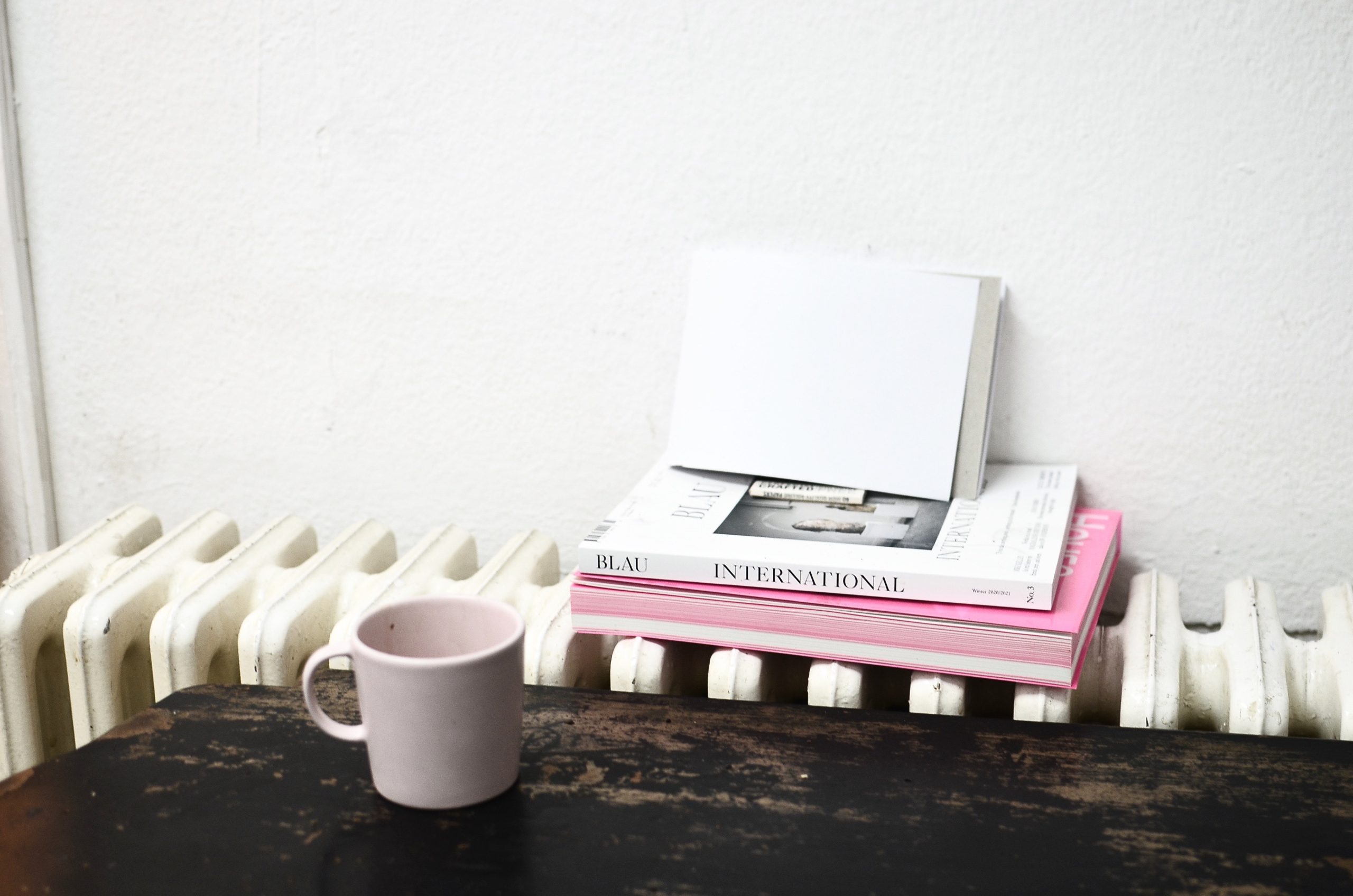 Ceramic cup on table near radiator