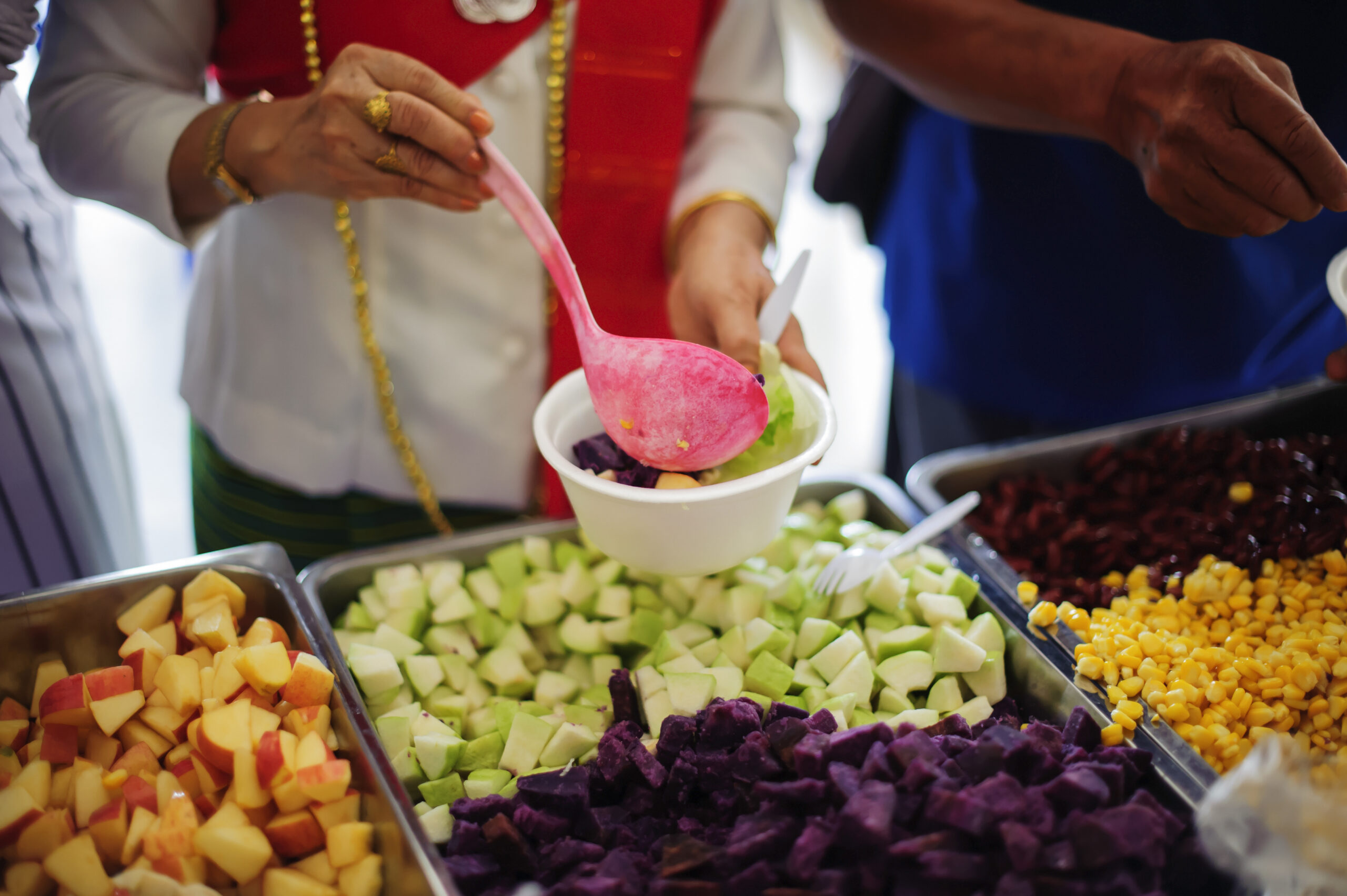 Volunteers serve food for charity