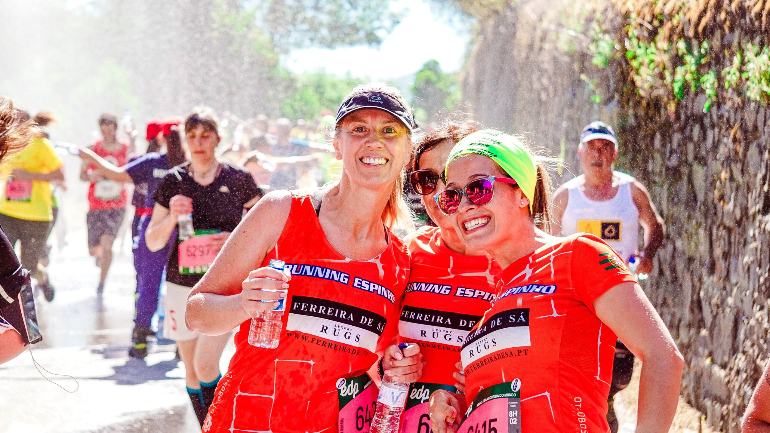 Three female runners taking a group photo