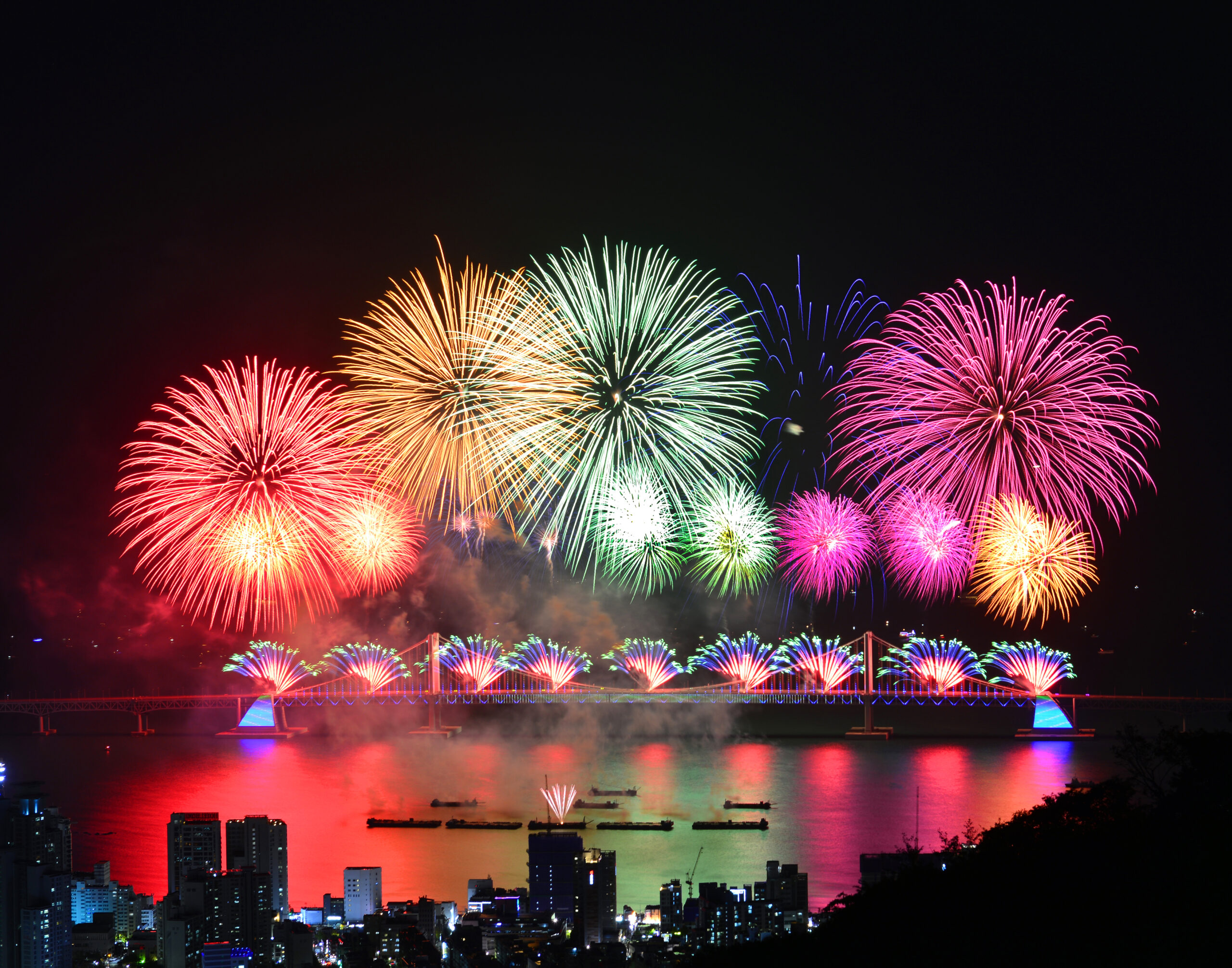 A skyline of fireworks lighting the night sky, Busan, South Korea.