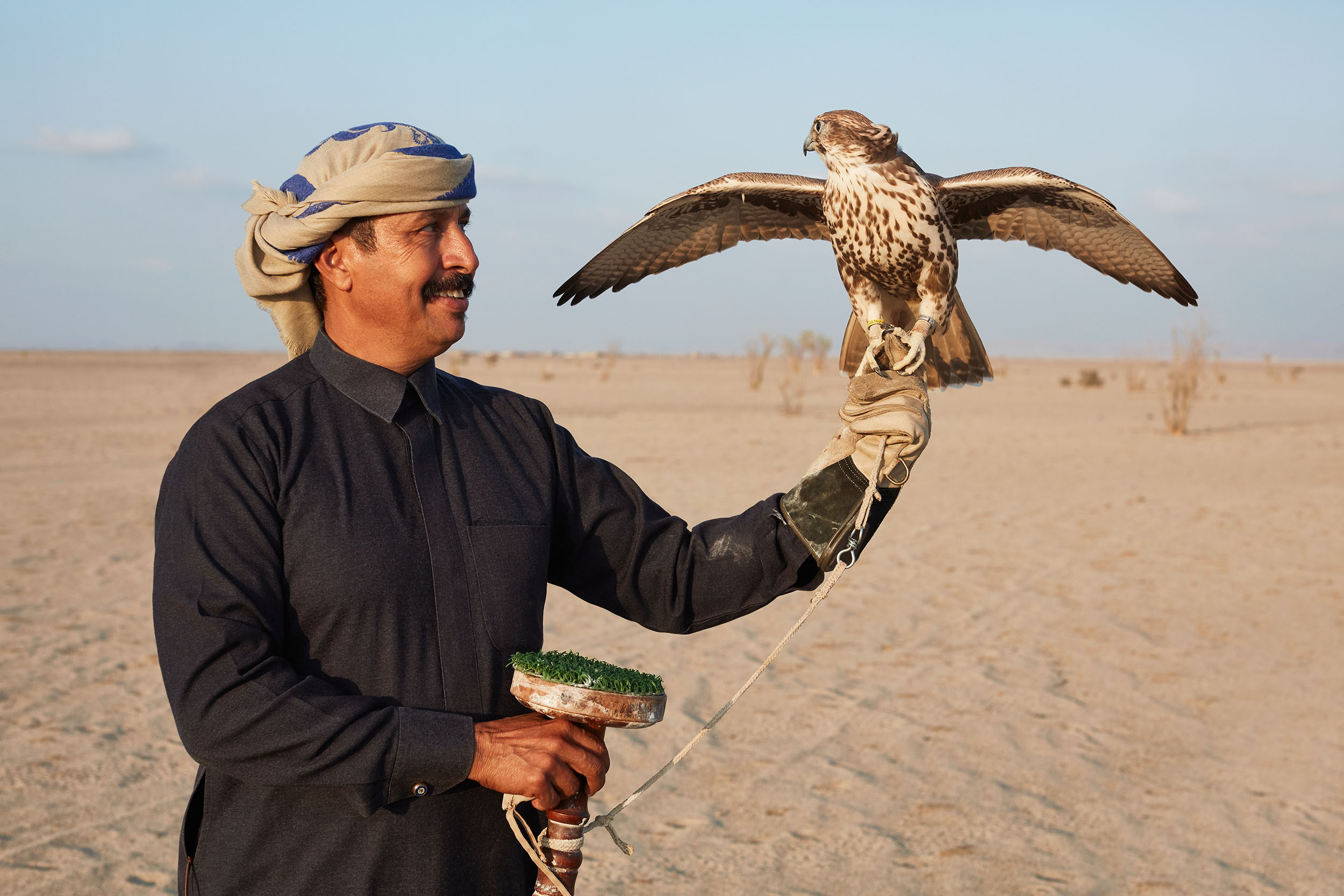 A falconer and his falcon at the Southern Dunes.