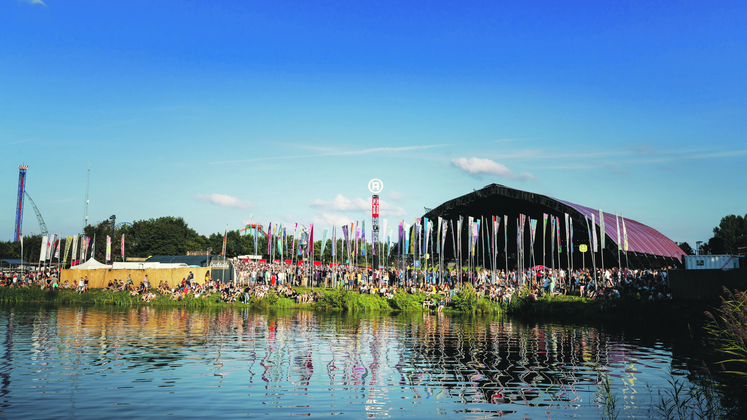 By the bank of a river, music lovers enjoy the Lowlands festival in the Netherlands.