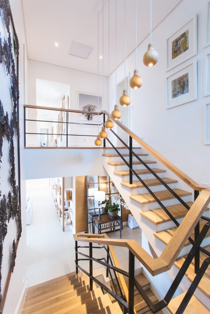 Brown staircase with pendant lights hanging from the ceiling