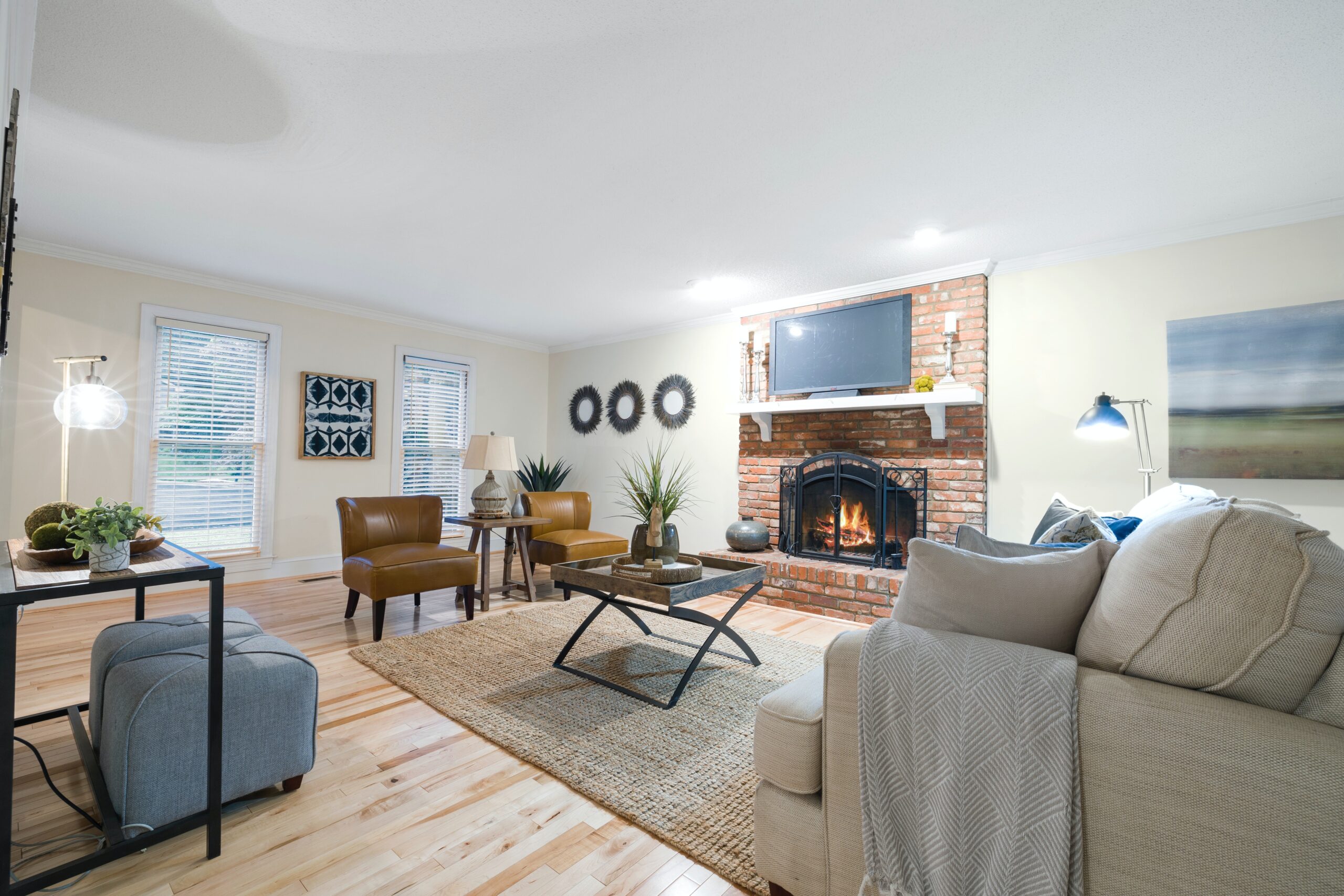 Living room with plush couch, armchairs and fireplace