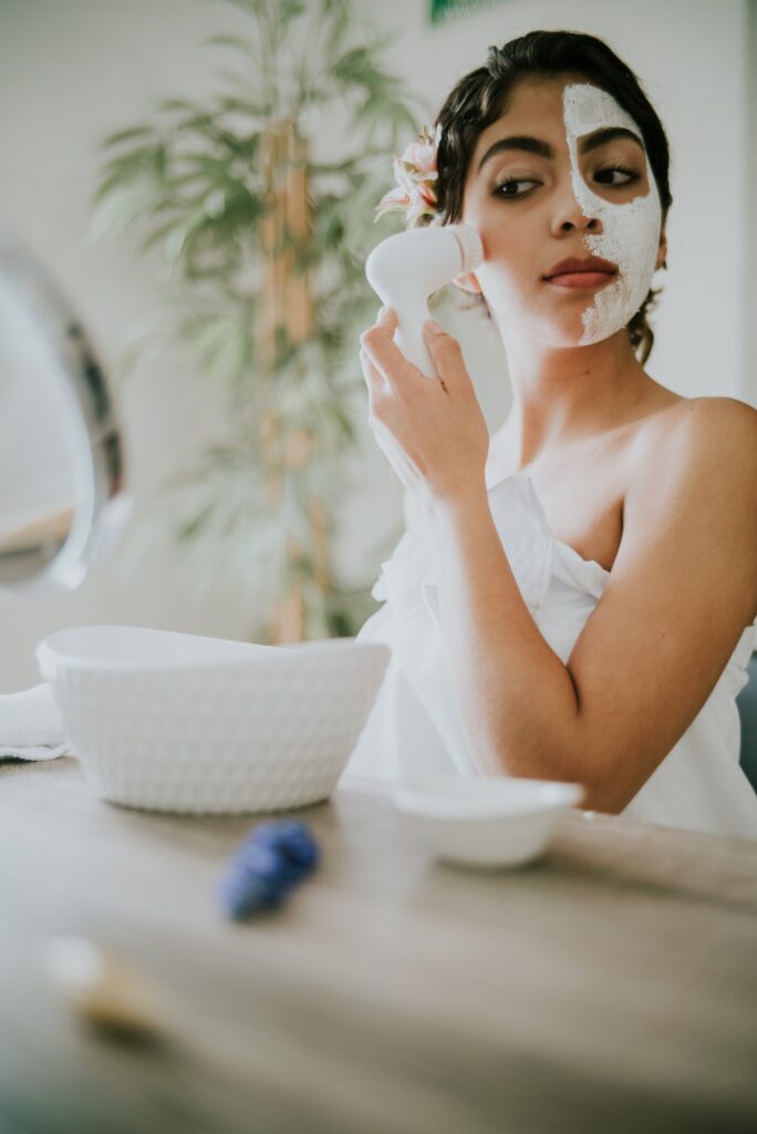 Woman with beauty mask on, massaging face