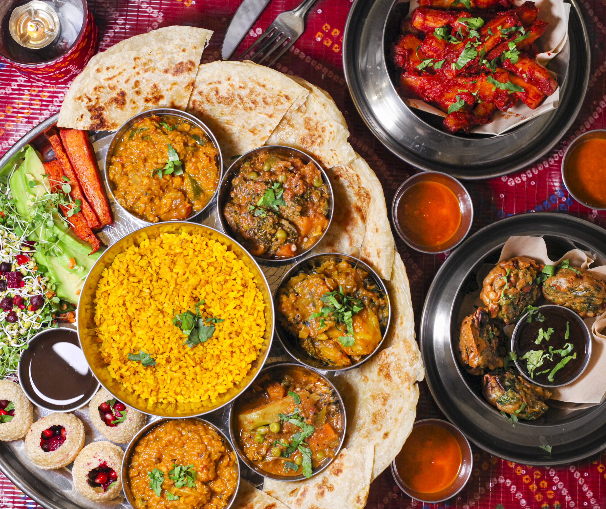 Indian vegan dishes with pittas and rice on a table