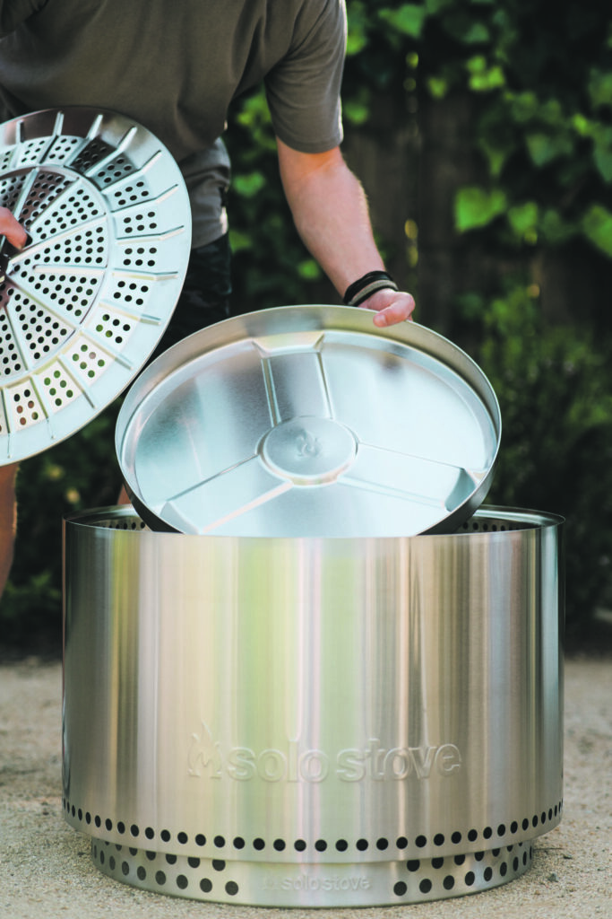 Man touching a steel firepit