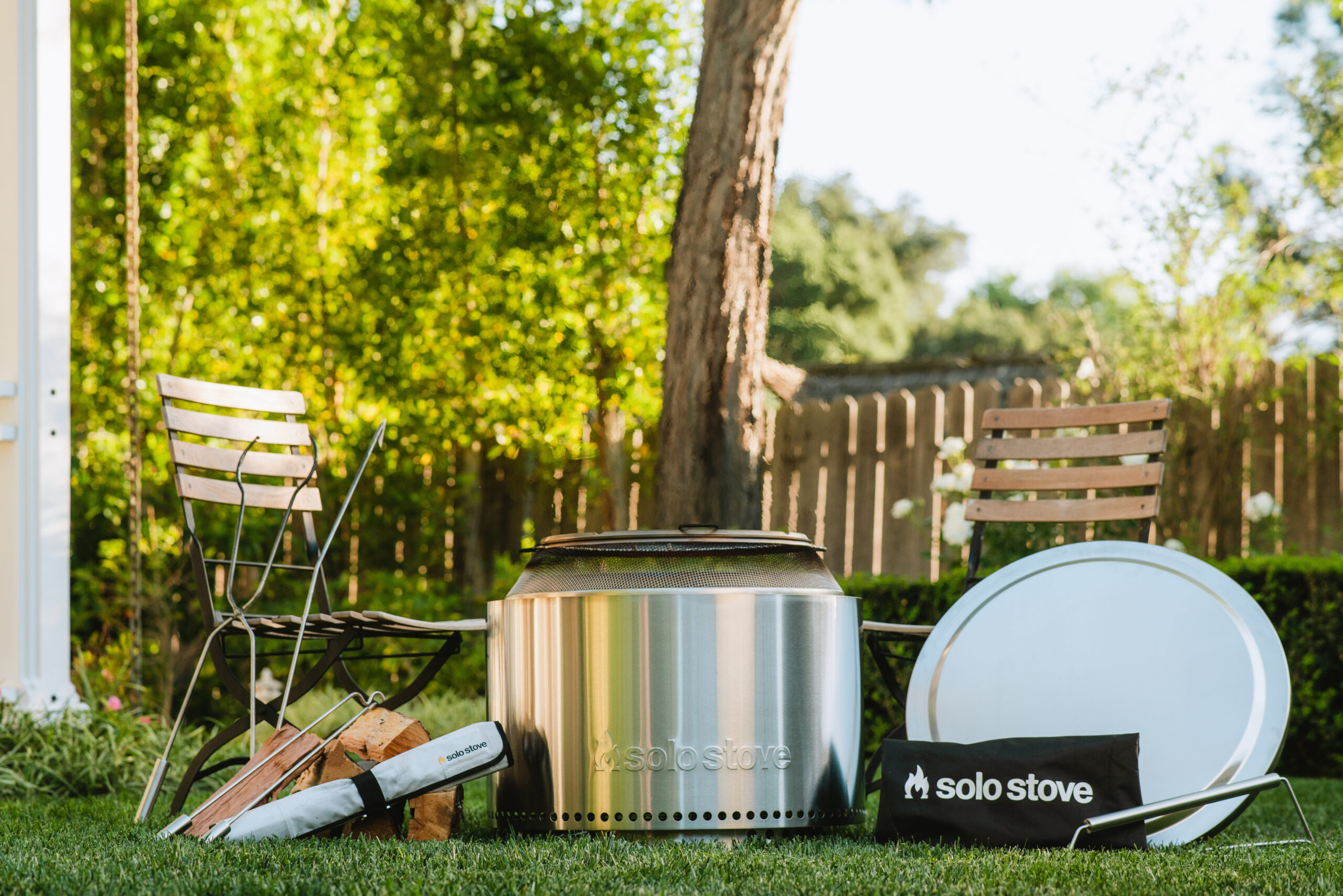 Firepit kit on the grass next to garden chairs