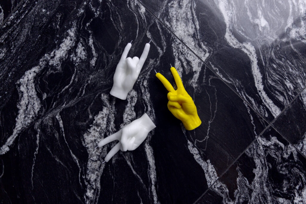 Candles in the shape of hand gestures 'peace' and 'rock on'