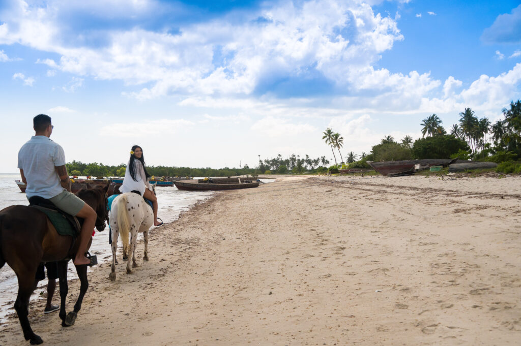 couple on horseback along the shores of Zanzibar