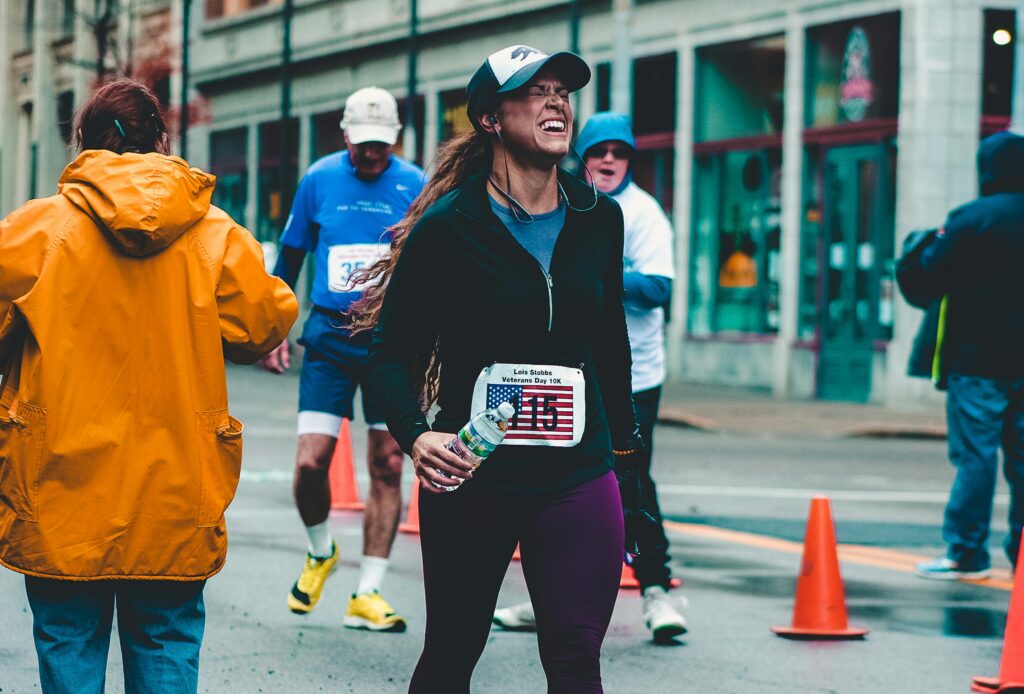 Woman finishing marathon drinking water