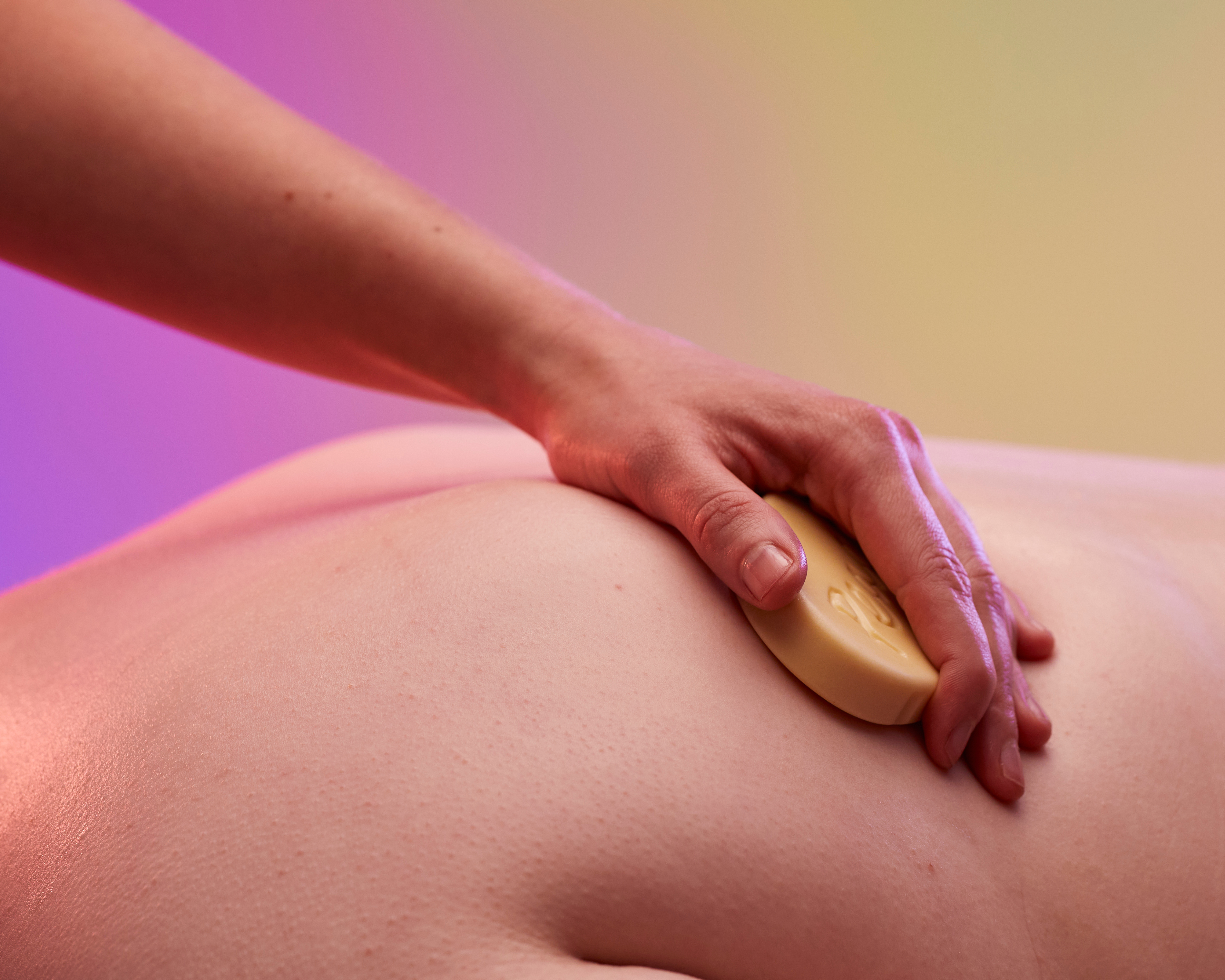 Girl getting a massage on a pink and yellow background